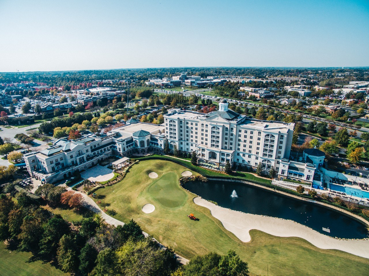 An aerial view of the Ballantyne Hotel and surrounding golf course, capturing the upscale charm and resort-style living that defines this South Charlotte community.