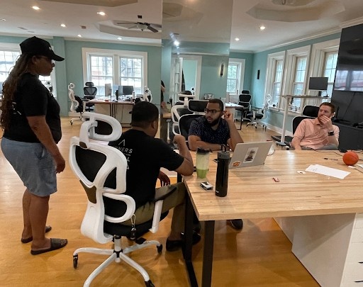 A group of people collaborating at a desk in a modern office setting.