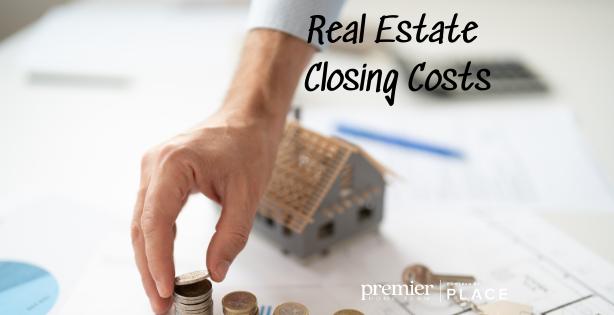 man placing coings on table, house behind his hand text:real estate closing costs