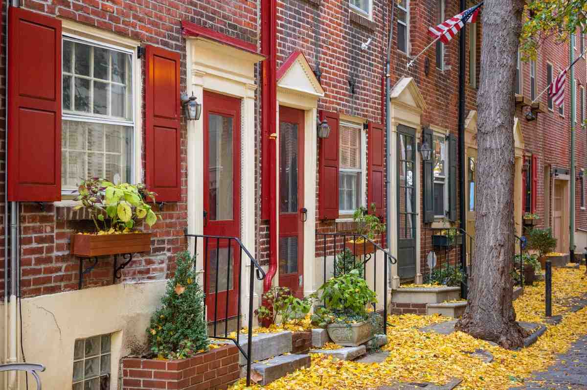 Historic Philadelphia rowhouses on an autumn street representing local Philadelphia real estate.