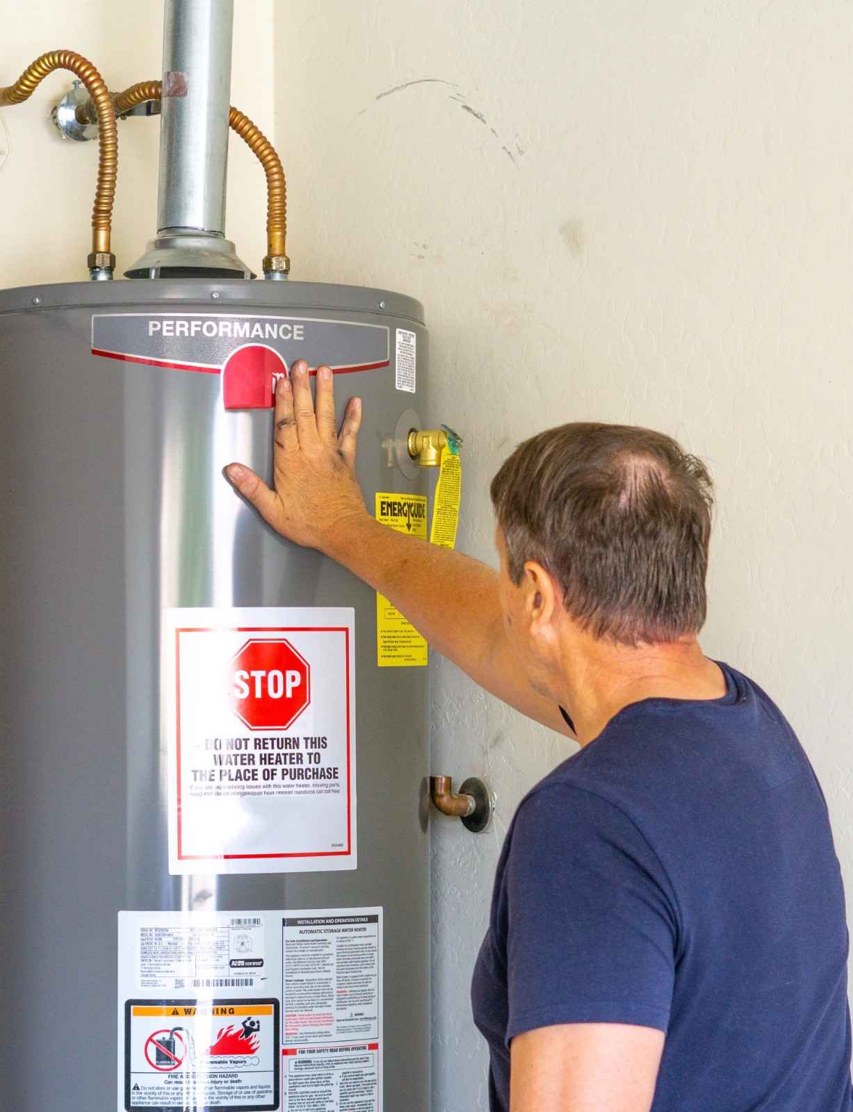 Buyer inspecting hot water heater during home inspection to identify potential issues before closing
