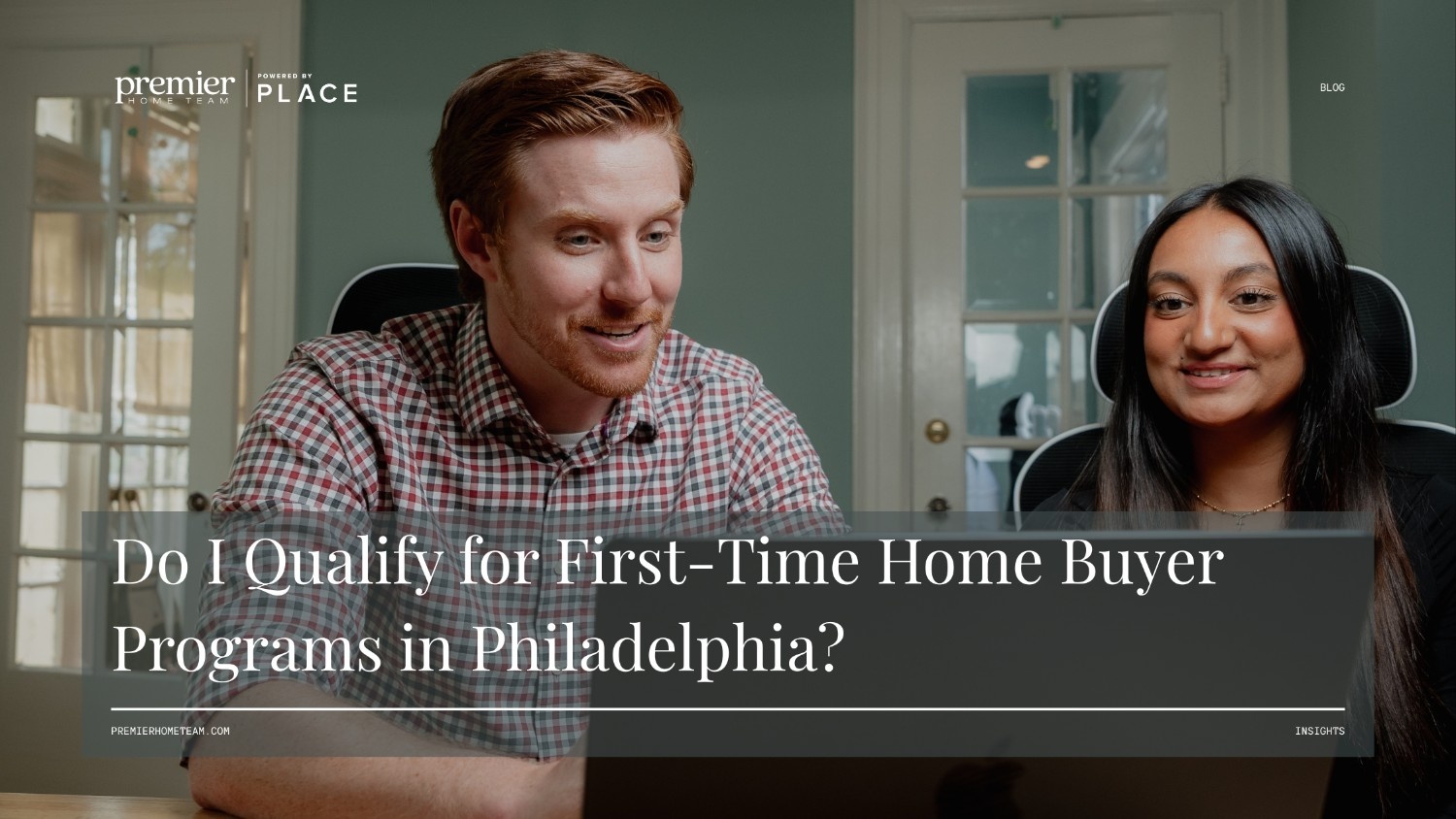 Two Philadelphia real estate professionals reviewing homebuyer guidelines on a laptop, featuring the text overlay 