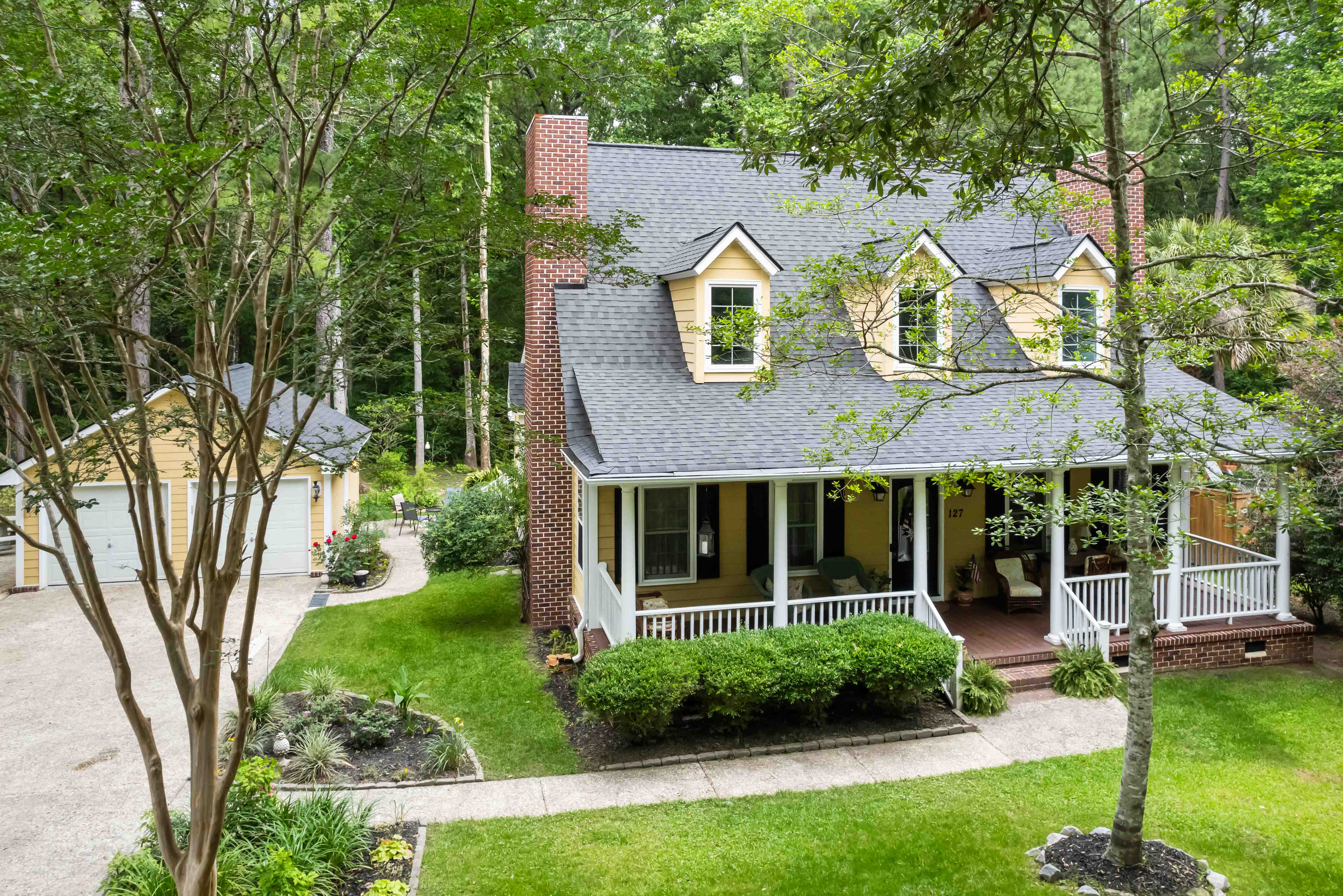 Front of a house with large front porch and detached garage