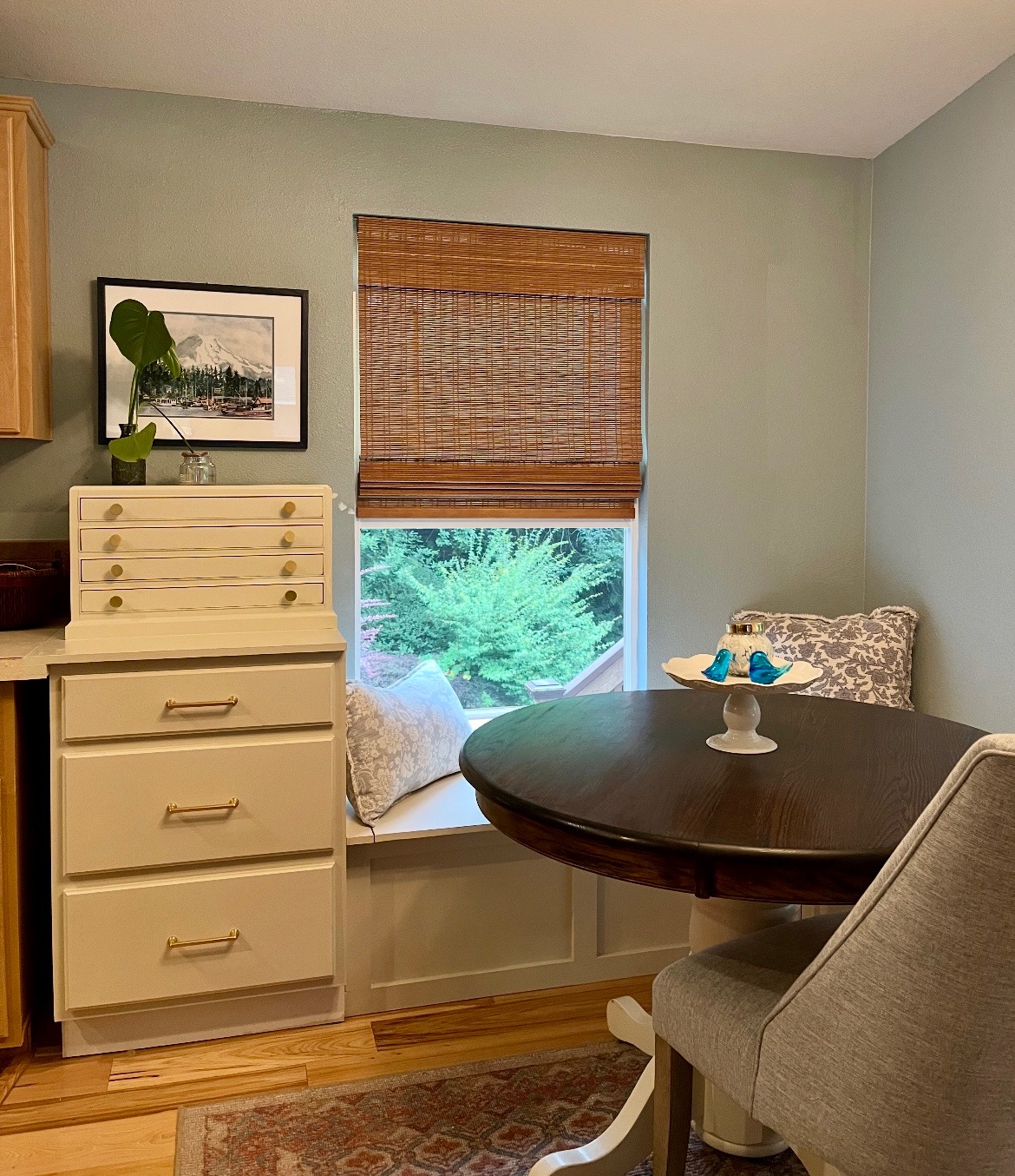 Cozy breakfast nook in a Tacoma, Washington home featuring repurposed estate sale furniture, woven window shades, and inviting seating — showcasing creative reuse ideas from an estate sale Tacoma Washington. Blog by the best real estate agent Tacoma WA for sustainable home design inspiration.