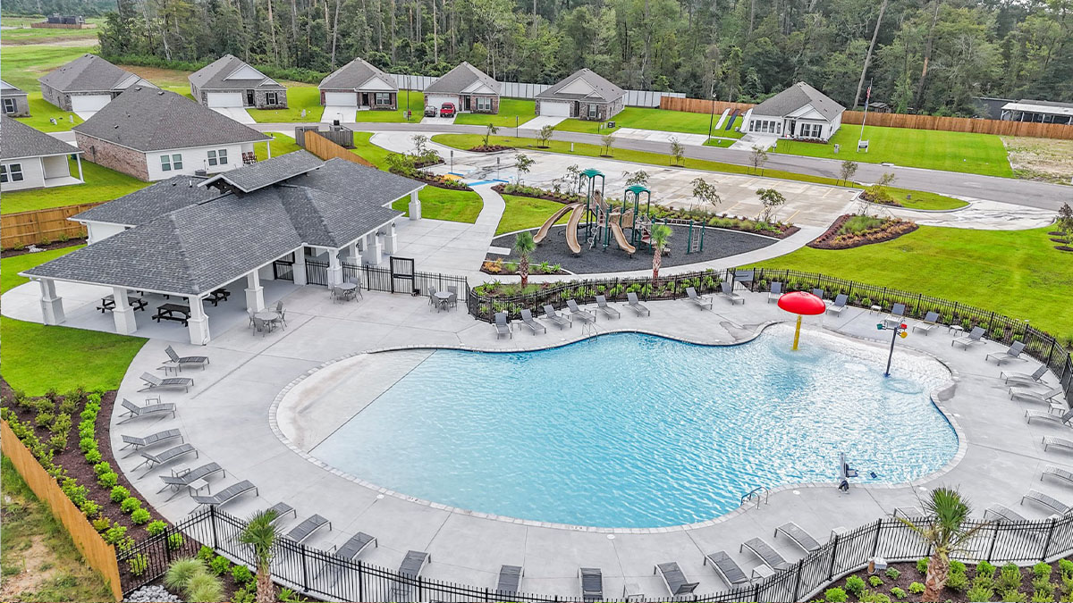 Belmont community in Denham Springs built by D.R. Horton featuring new single-family homes, landscaped yards, and a central pool with playground area.