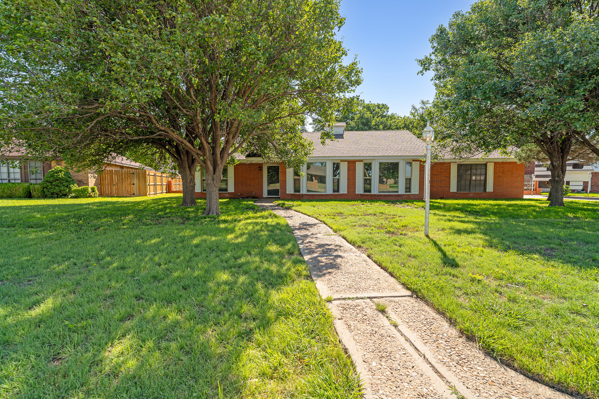 Front view of 1604 Country Lane home in Panhandle TX listed by Green Door Group, showing spacious lot and country-style living near Amarillo