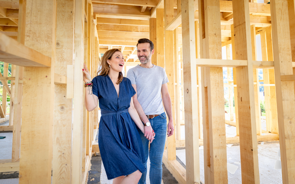 Home buyers walking through a new construction home during the pre-drywall framing stage in the Triangle area.
