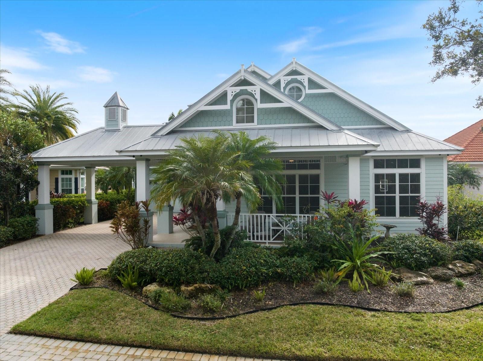 Charming Gulf Coast Florida home with lush tropical landscaping and metal roof for sale in Sarasota area
