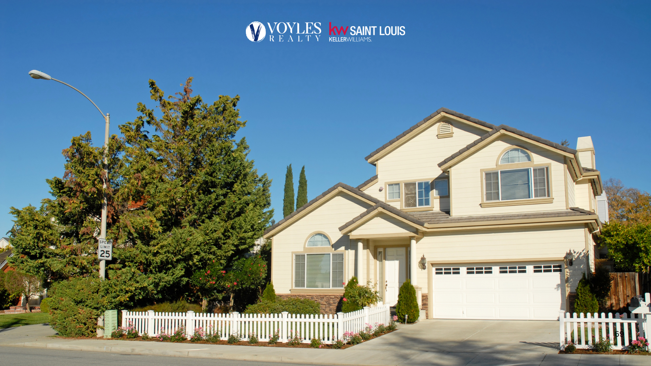 A beautiful two-story beige family home with a white picket fence, green landscaping, and a clear blue sky, representing the type of house home buyers regret missing.