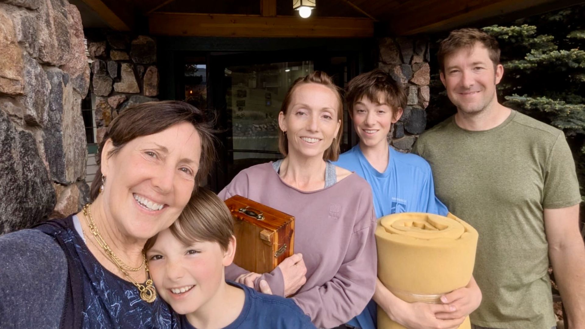 A Foothills Colorado family all posing and smiling at the camera