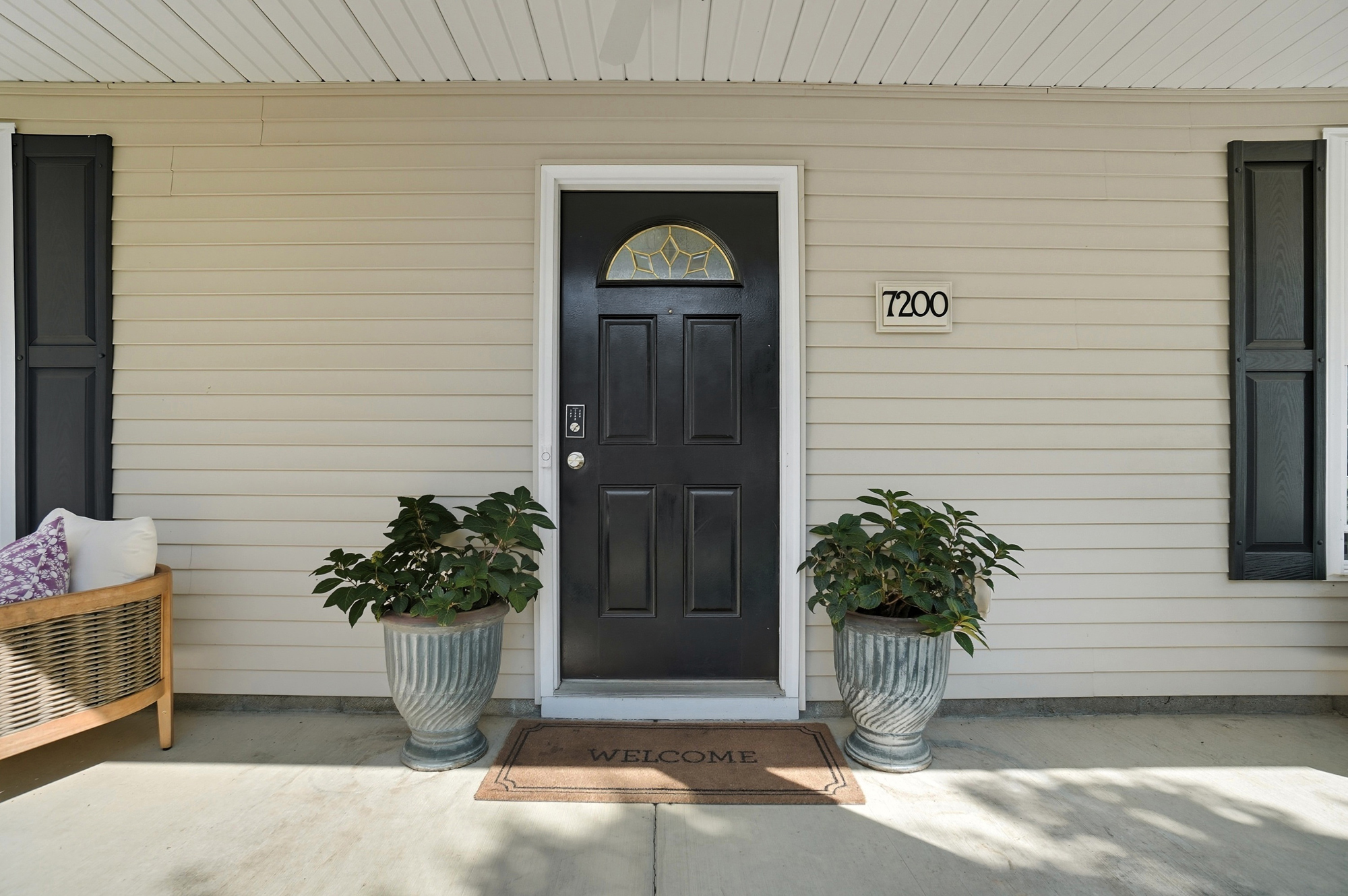 Welcoming front entrance accented with planters