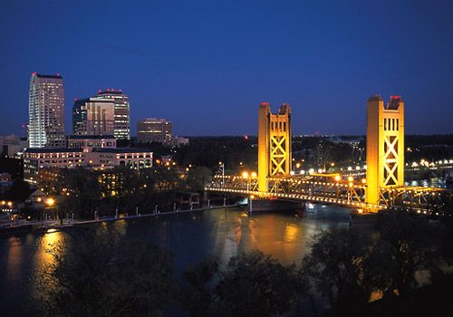 Downtown Sacramento skyline with the Tower Bridge crossing the Sacramento River at sunset