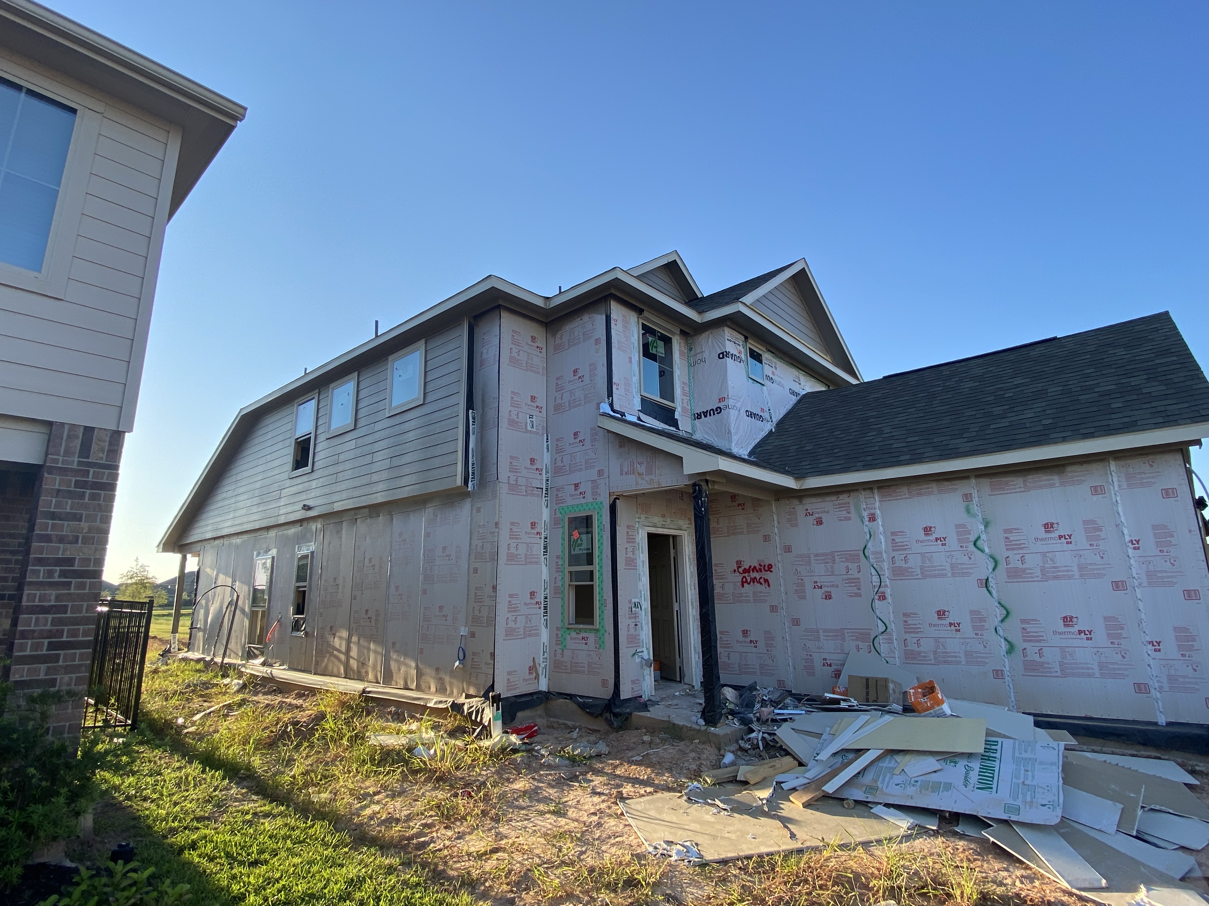 A REALTOR® touring a newly constructed home with buyers in Katy, Texas.