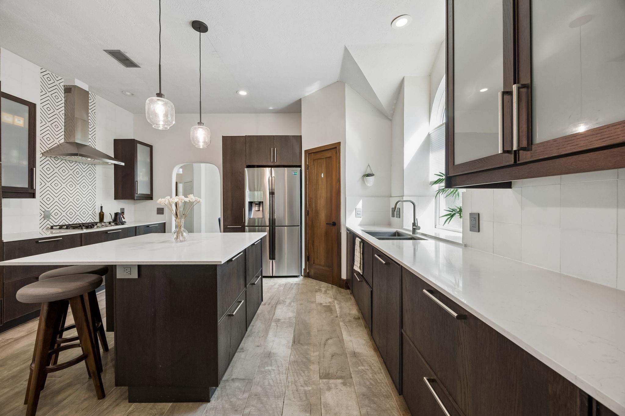 Jonathan McNabb reviewing a home-selling strategy at a kitchen island in Katy, TX.