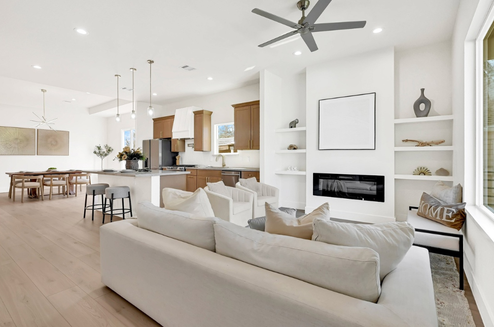 Open-concept living room and kitchen with vaulted ceilings, large island, stainless steel appliances, wine bar, and modern farmhouse finishes at 4720 Providence Street in Houston.