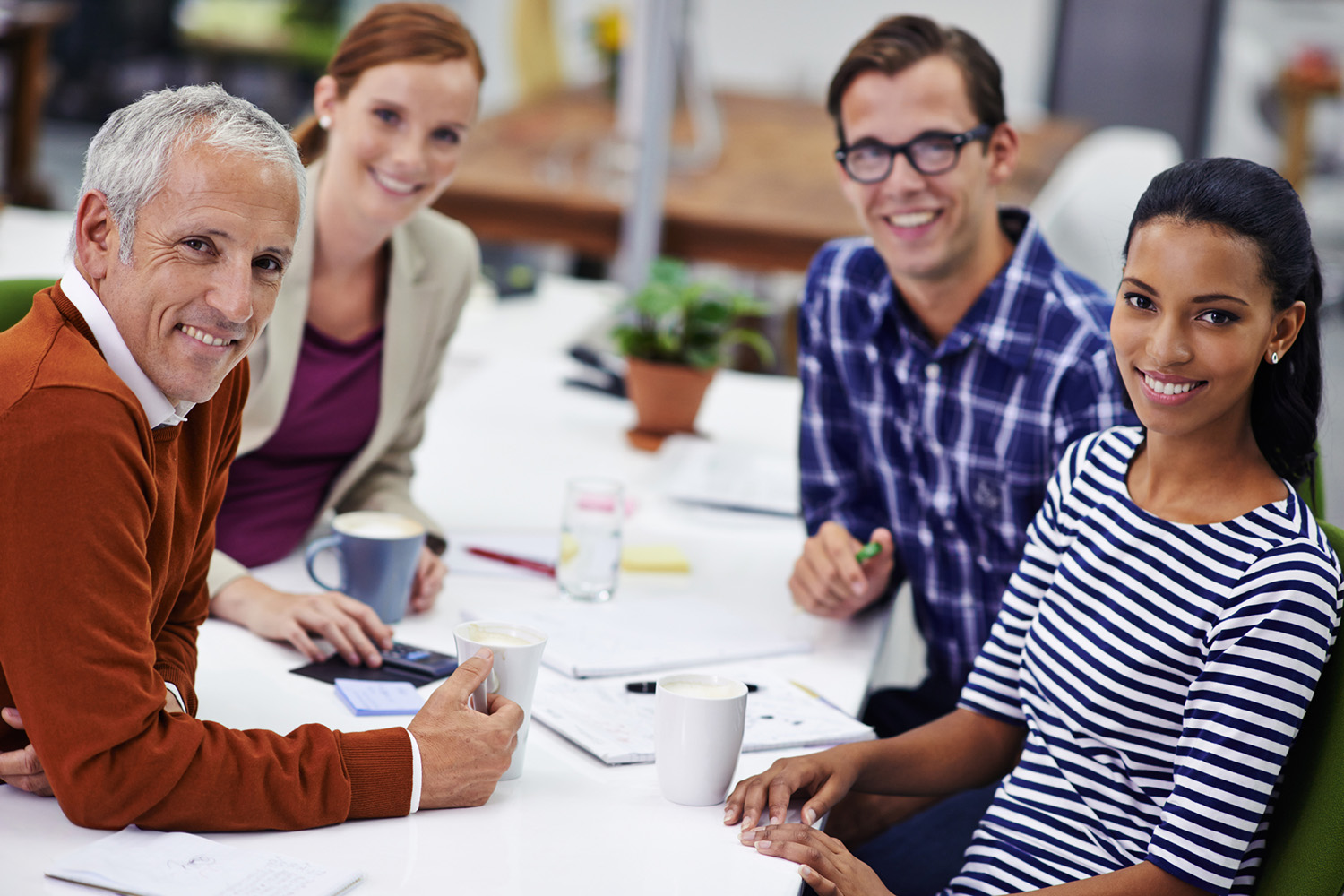 A portrait of happy coworkers sitting in their office