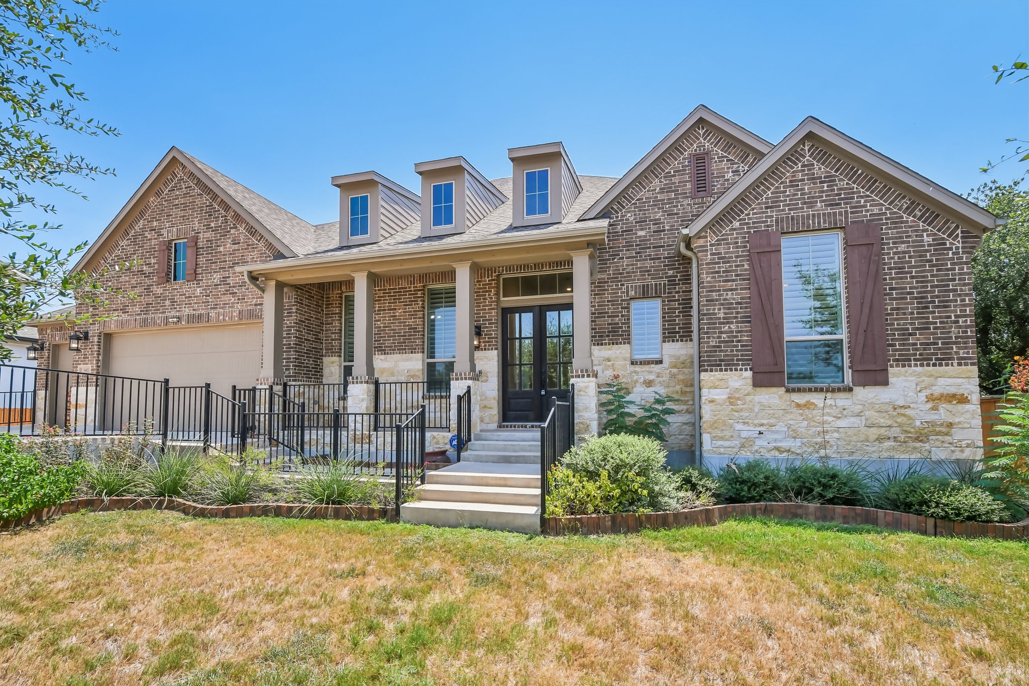 Front exterior of 545 Copper Sage Drive, a brick and stone home in La Cima, San Marcos, TX