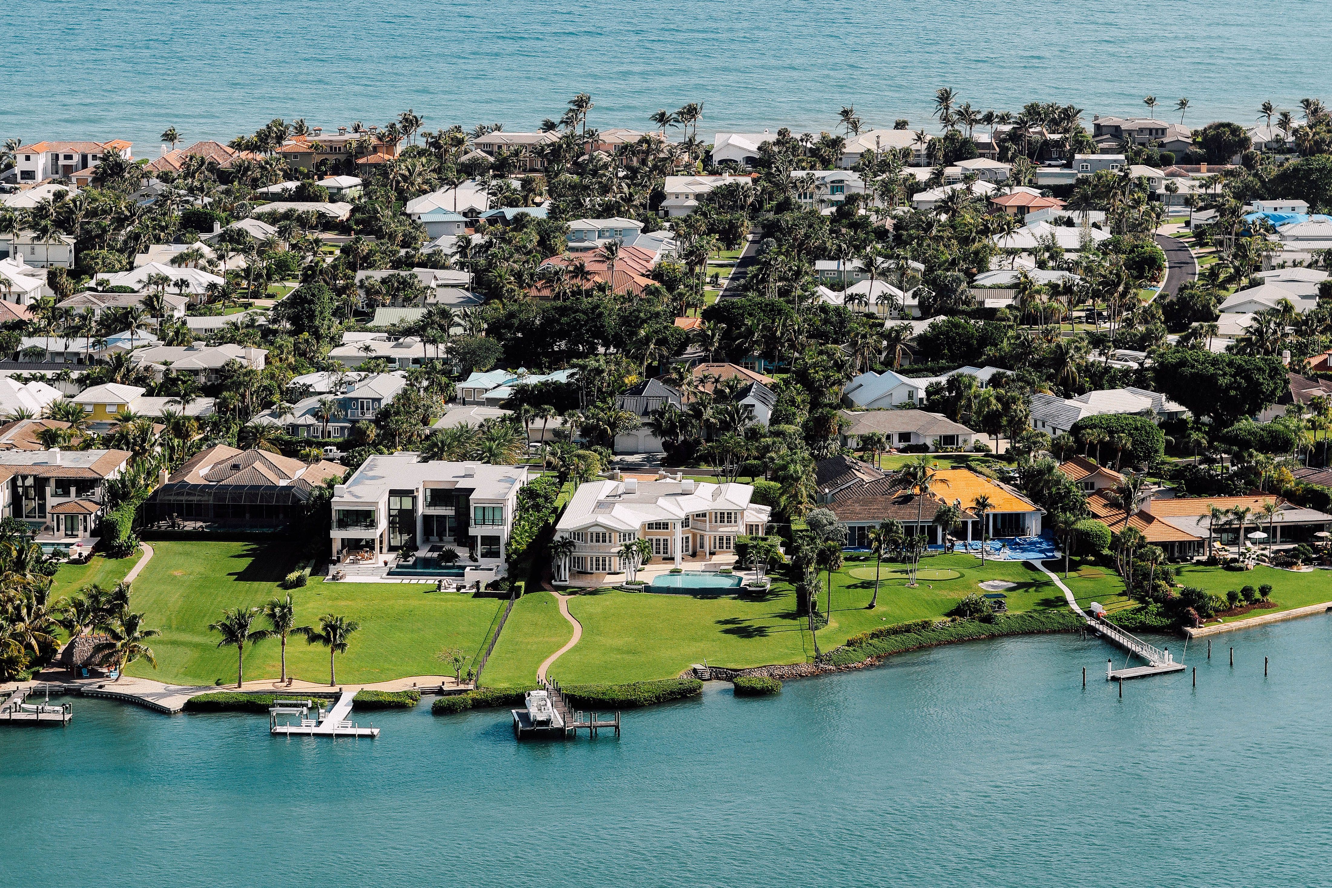Luxury waterfront home in Cape Coral, Florida with Gulf access, private dock, boat, pool, and tropical landscaping. 