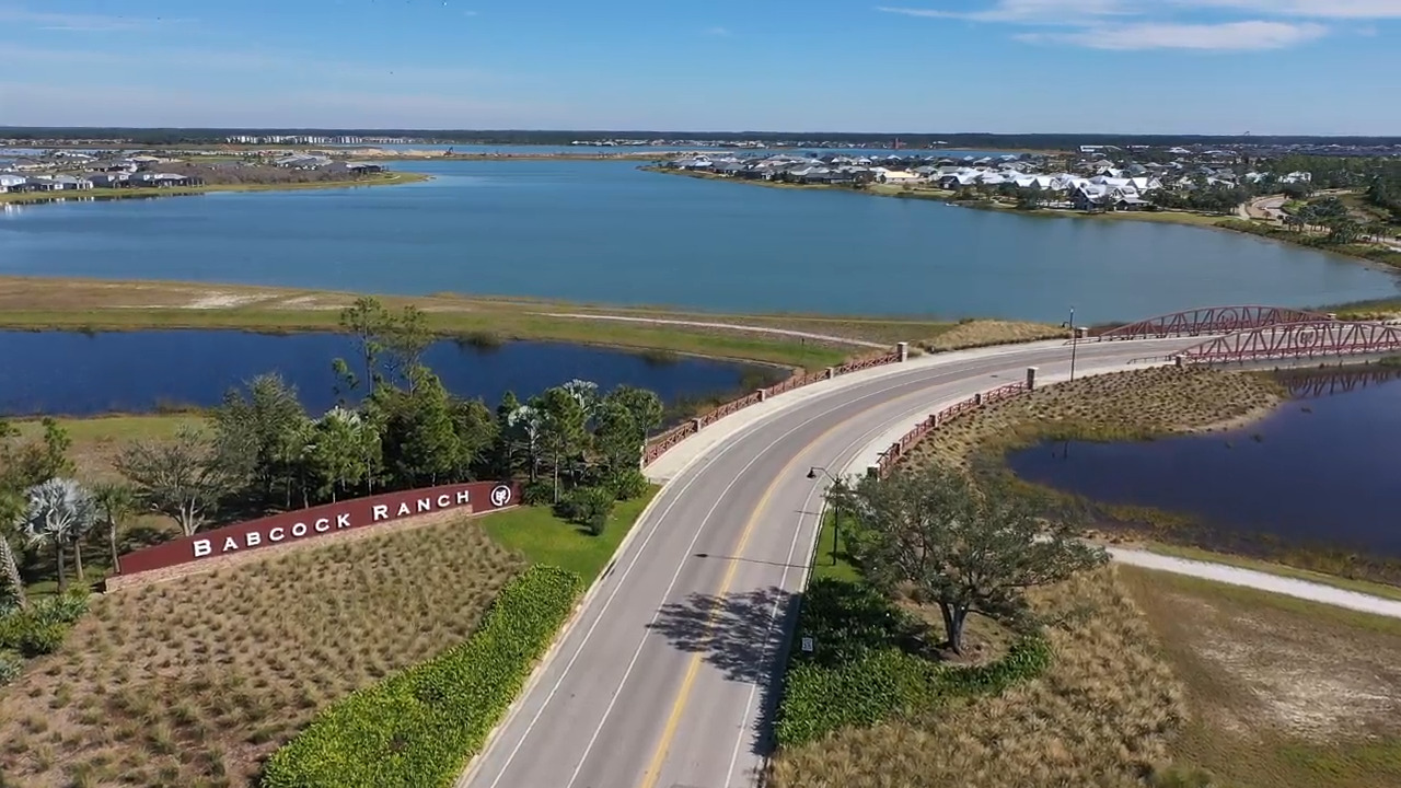 Aerial view of Babcock Ranch, Florida, with solar-powered homes, lakes, green spaces, and community amenities under Florida sunshine.