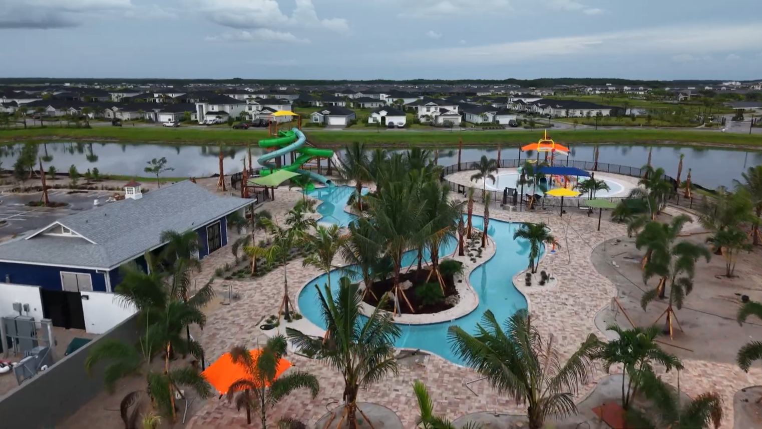 Aerial view of Babcock Ranch neighborhoods in Southwest Florida, featuring lakefront villas, townhomes, single-family homes, parks, and walking trails.