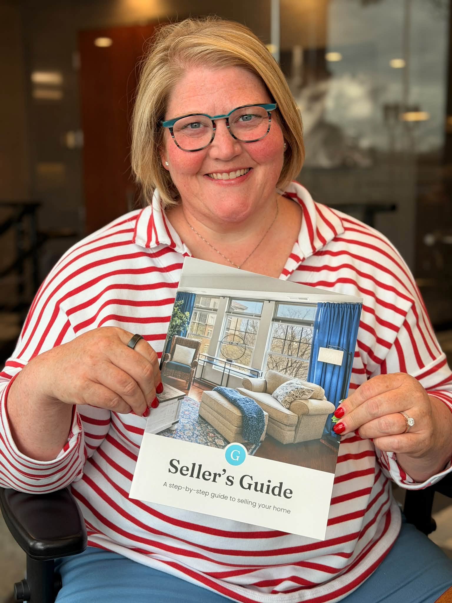 Sarah Huffman holding AGLG's free guidebook for sellers