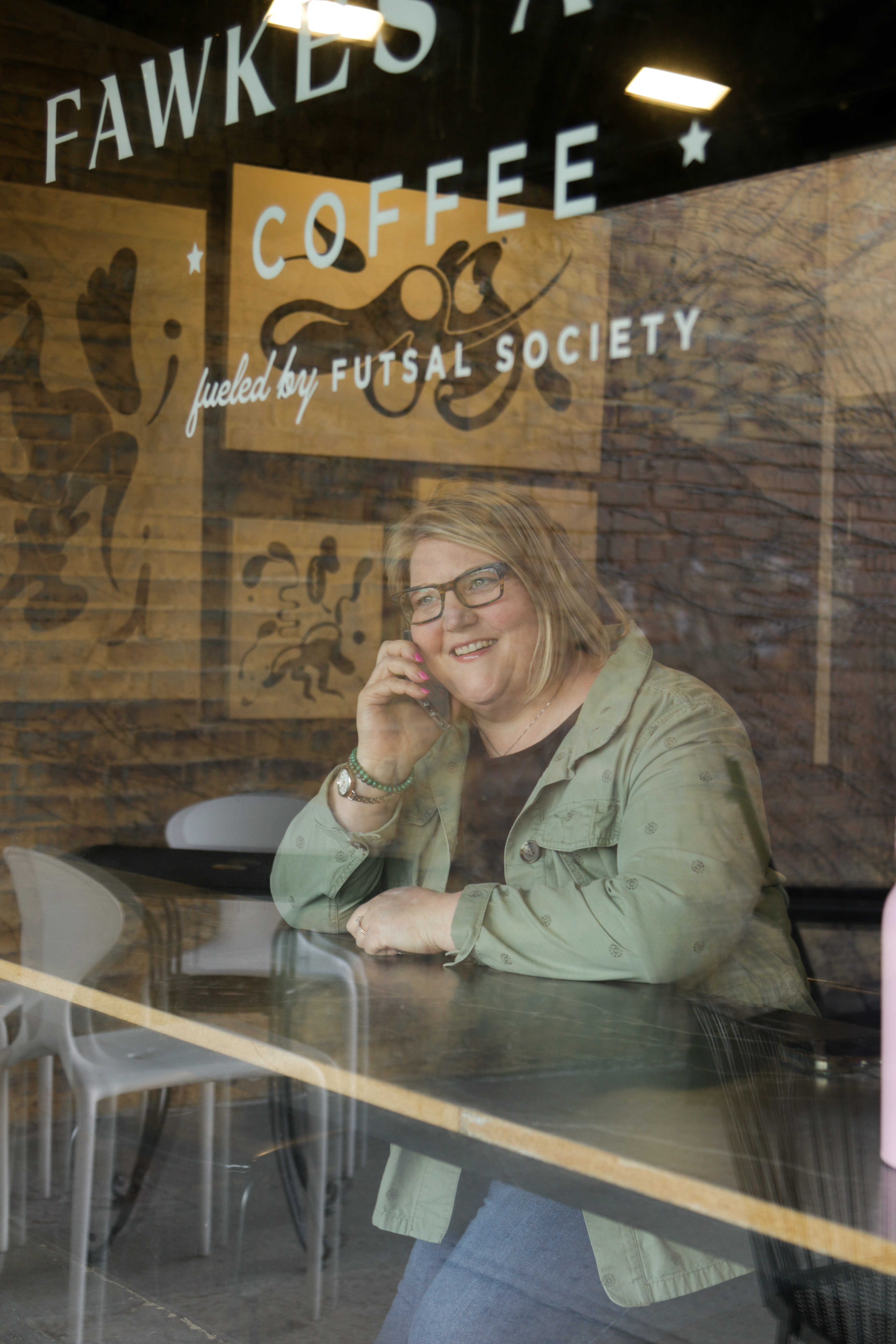 Sarah Huffman taking a call at Fawkes Alley Coffee in Minneapolis