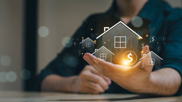 Miniature house in a person's hand symbolizing real estate investment and financial growth