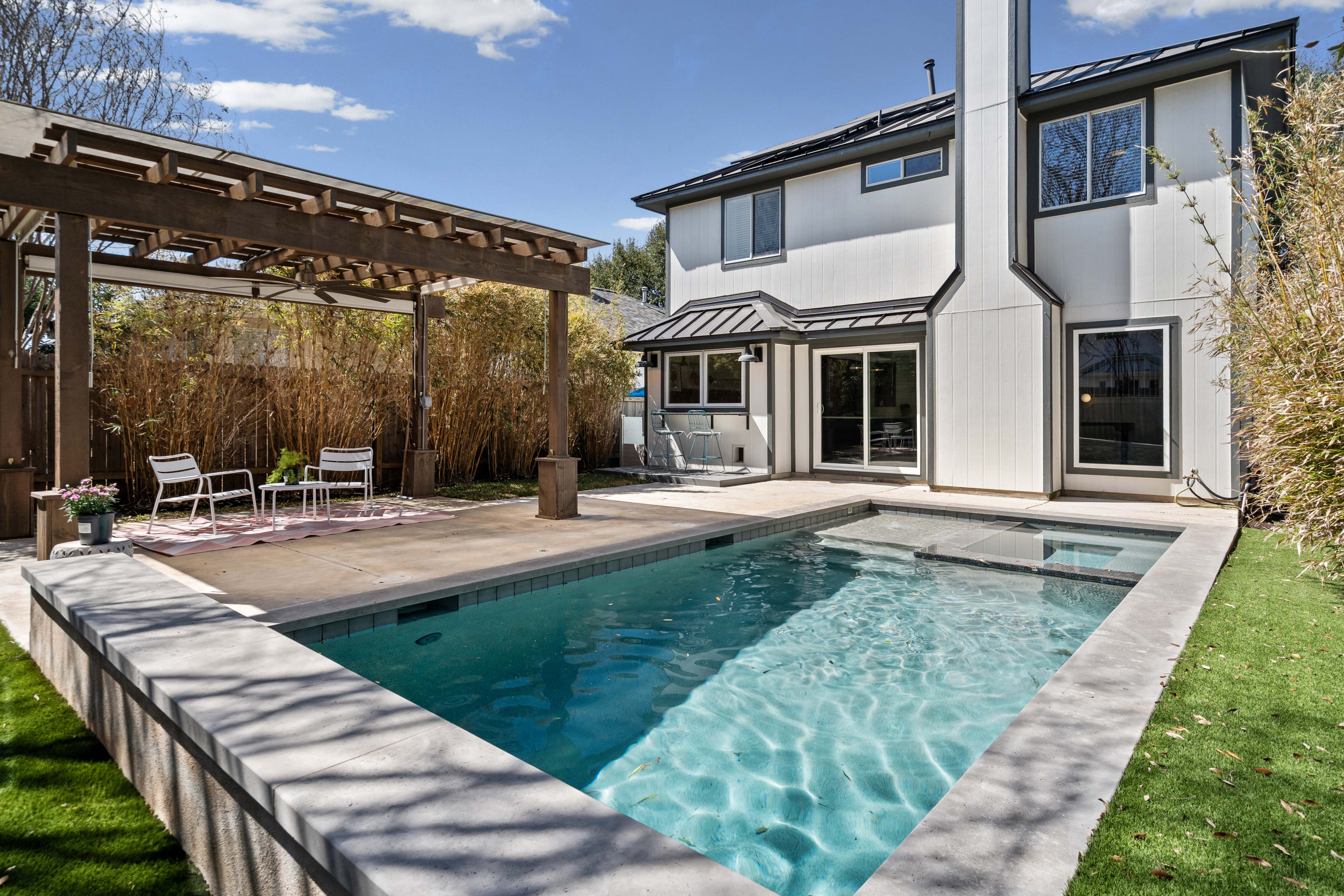 backyard of the home with sparkling pool