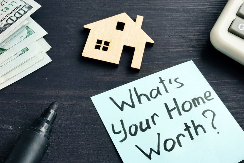 Person using a home value tool to estimate property worth in Birmingham AL