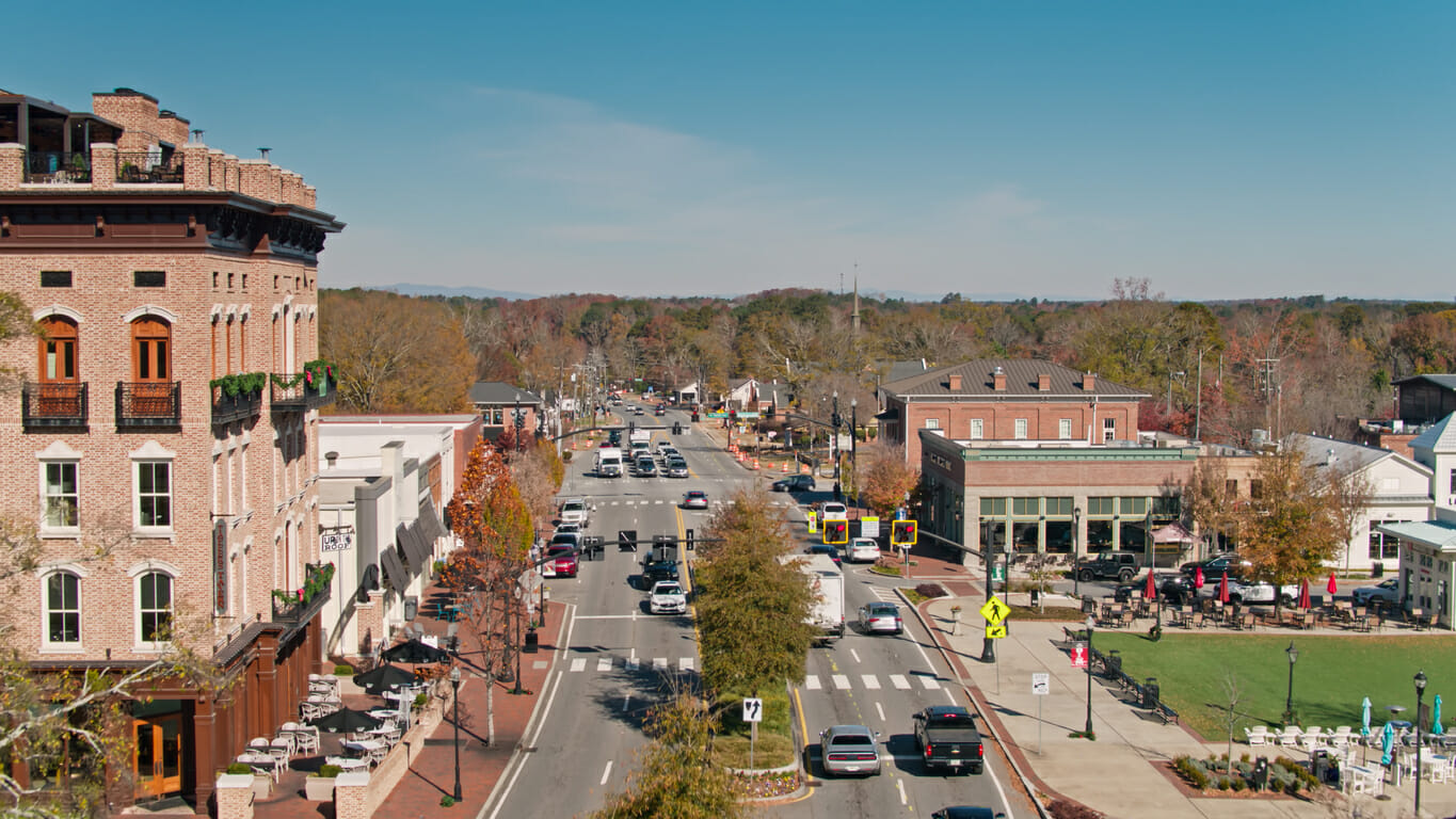 Downtown Alpharetta streetscape with shops, restaurants, and families enjoying the day