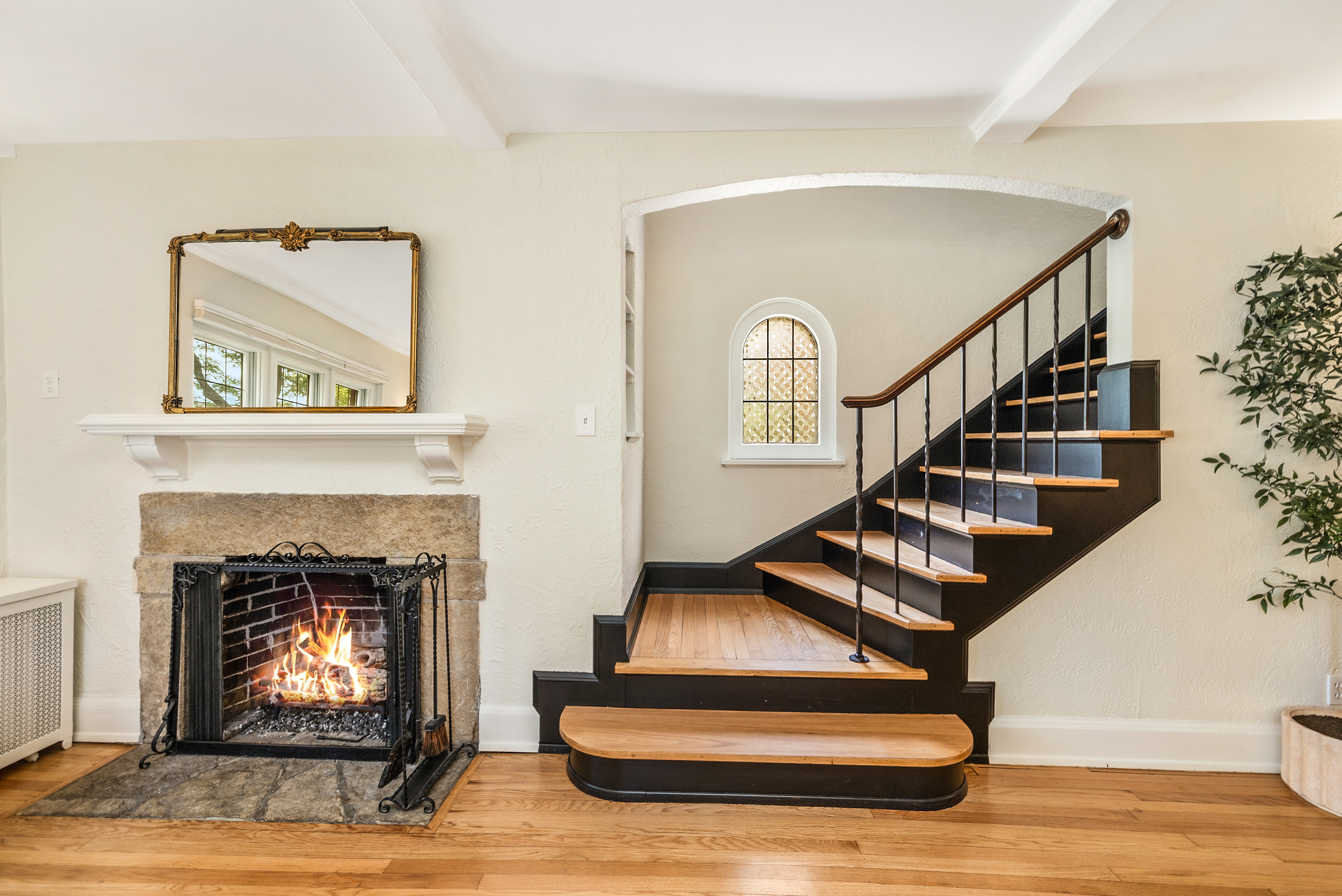 Charming Tudor Stairwell with Fire burning in Fireplace