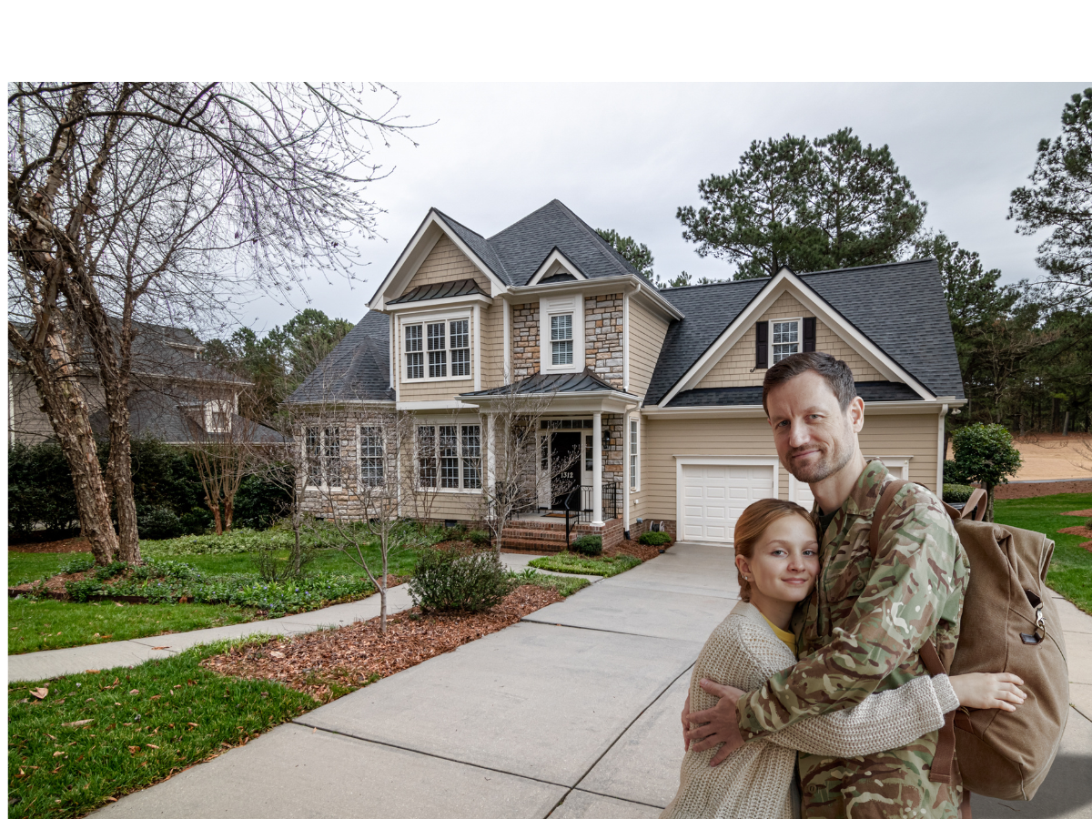  service member embracing family in front of a large home. 