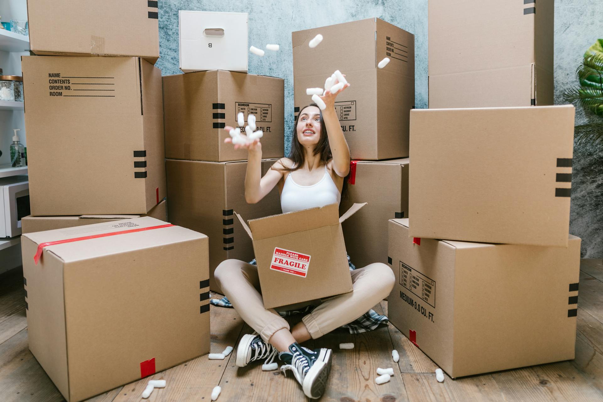 Photo by RDNE Stock project: https://www.pexels.com/photo/woman-in-black-tank-top-sitting-on-brown-cardboard-box-7464725/