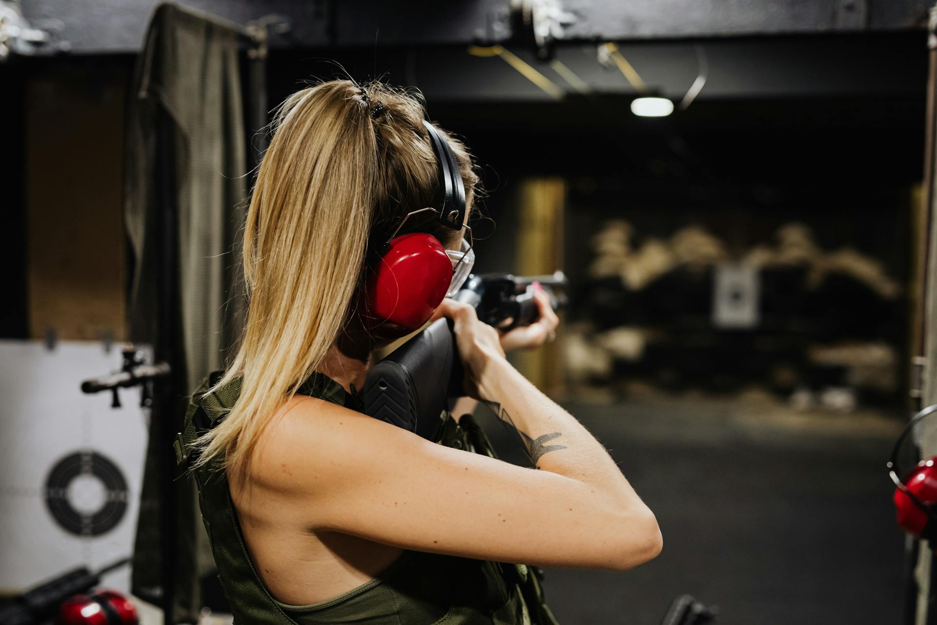 Photo by Karolina Grabowska www.kaboompics.com: https://www.pexels.com/photo/a-woman-in-black-tank-top-holding-black-rifle-5202391/