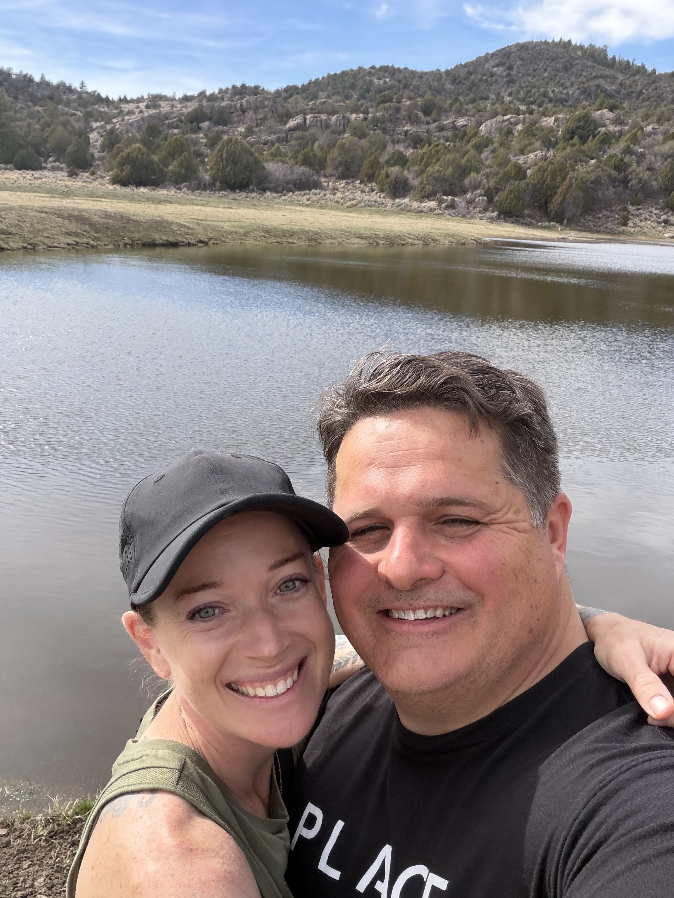 Hikers celebrating after reaching a hidden mountain reservoir during a Southern Utah backcountry adventure