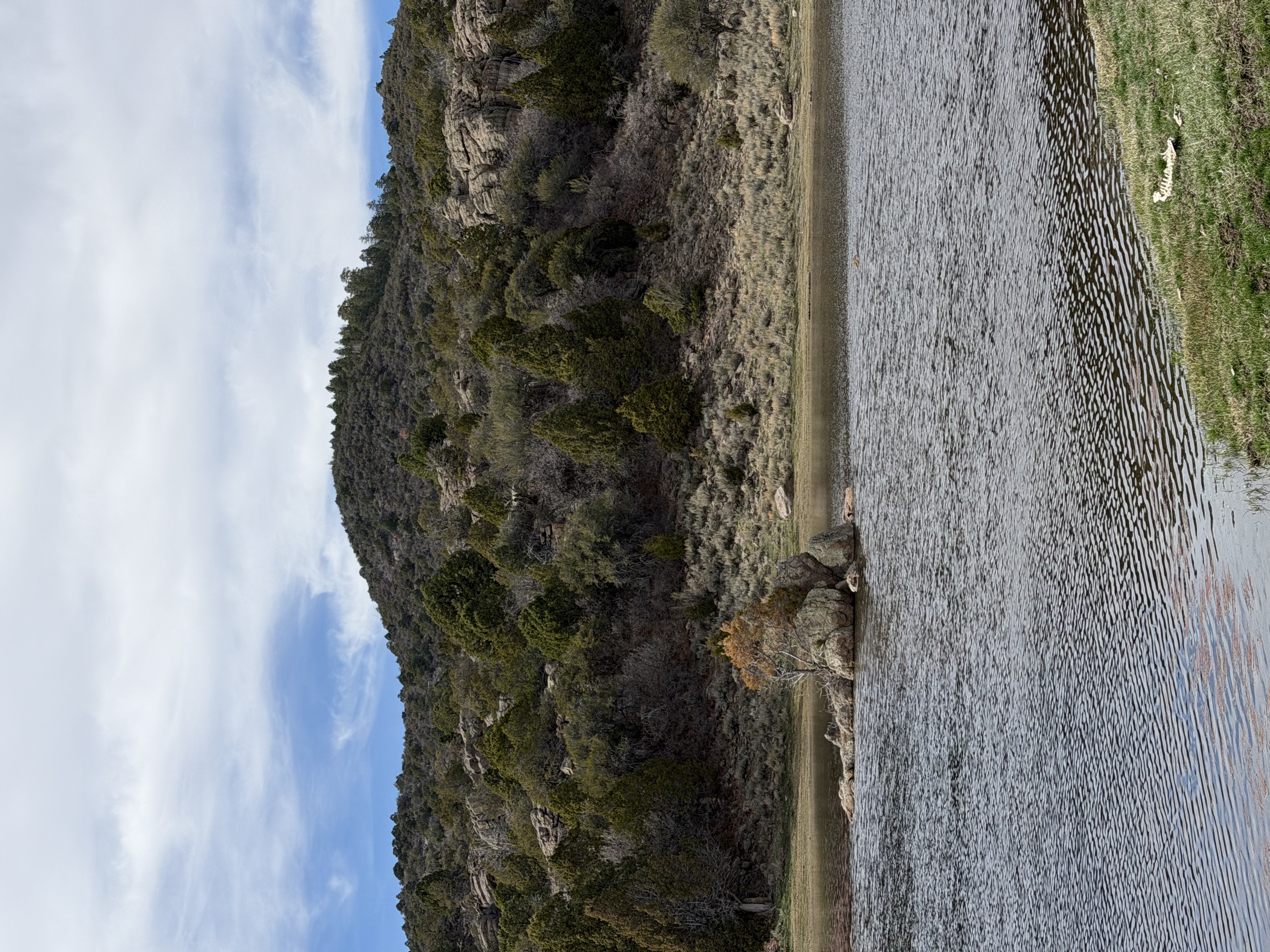 Hidden mountain reservoir surrounded by juniper-covered hills near Old Iron Town in Southern Utah