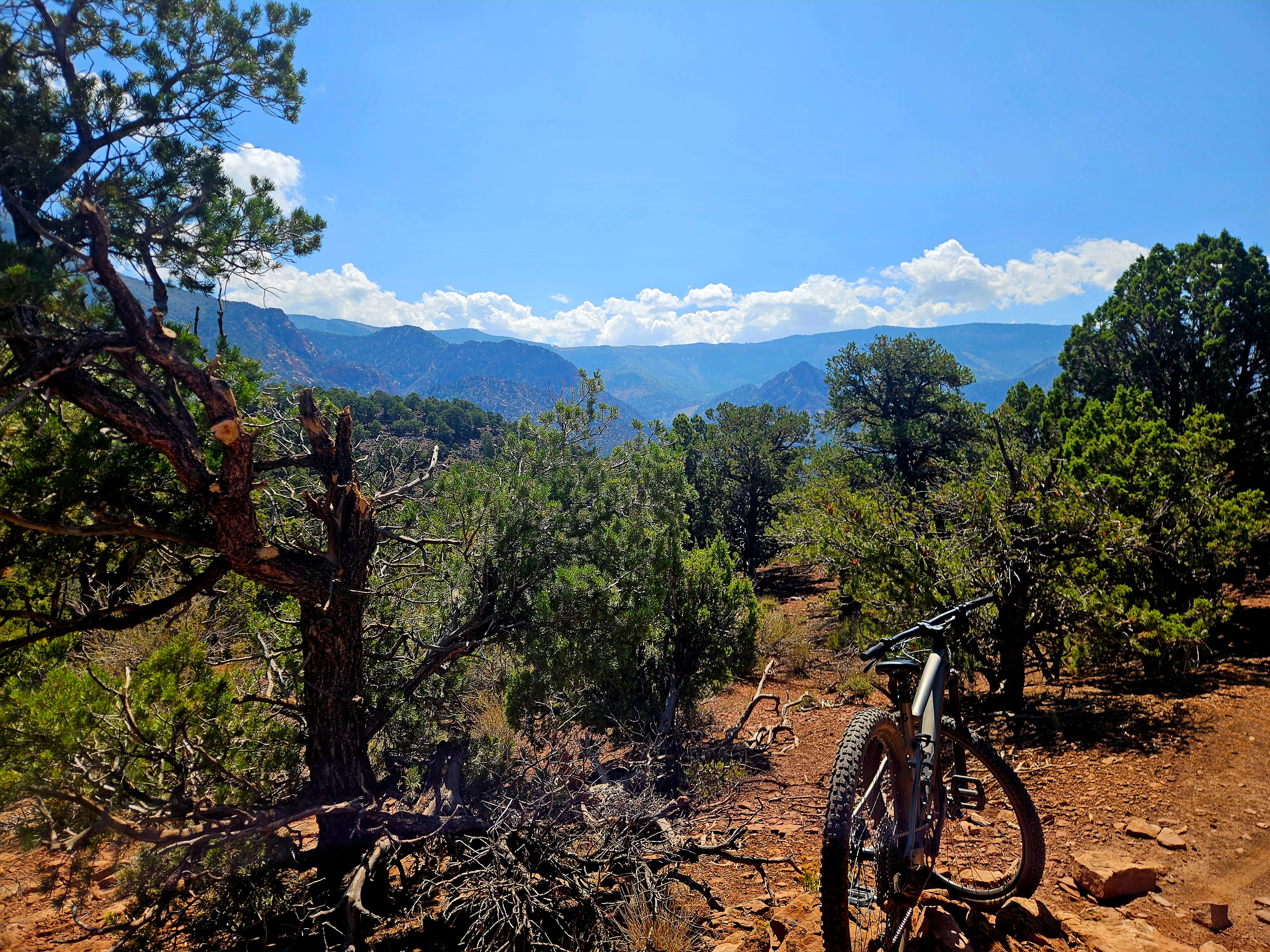 Wide landscape view of Iron Hills Trail System showing volcanic rock formations and desert singletrack in Southern Utah