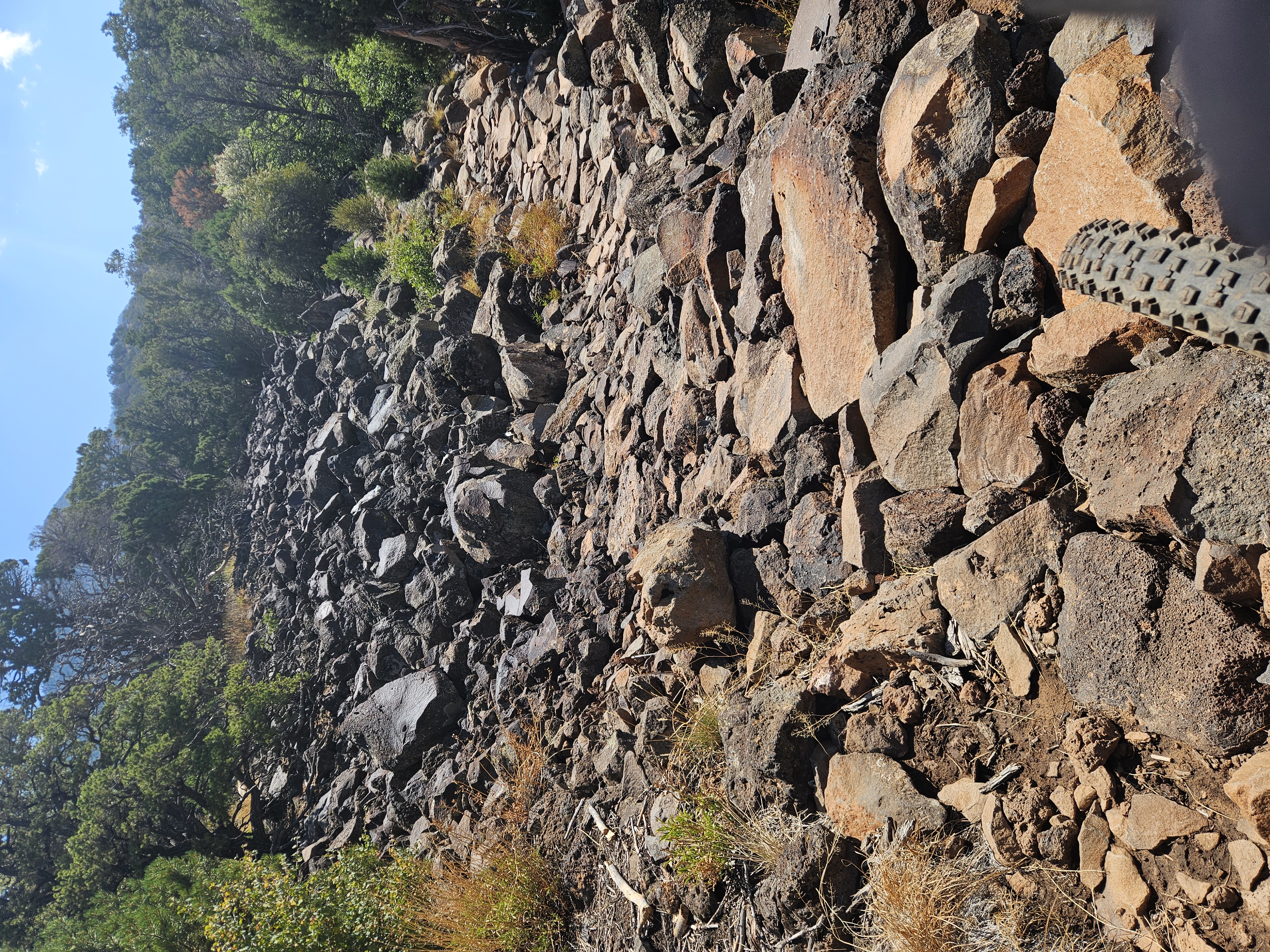 Rugged volcanic basalt rock sections along Iron Hills Trail mountain bike route in Southern Utah
