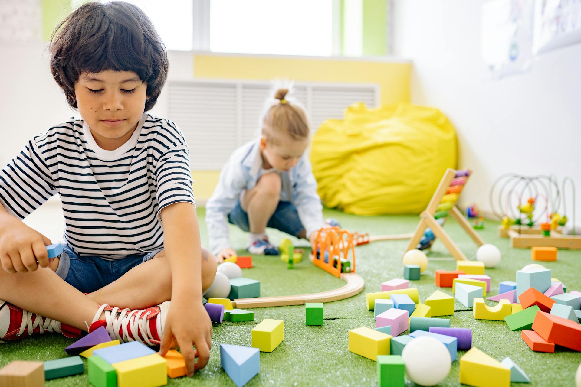 Photo by Yan Krukau: https://www.pexels.com/photo/two-boys-playing-with-wooden-blocks-in-a-room-8612970/