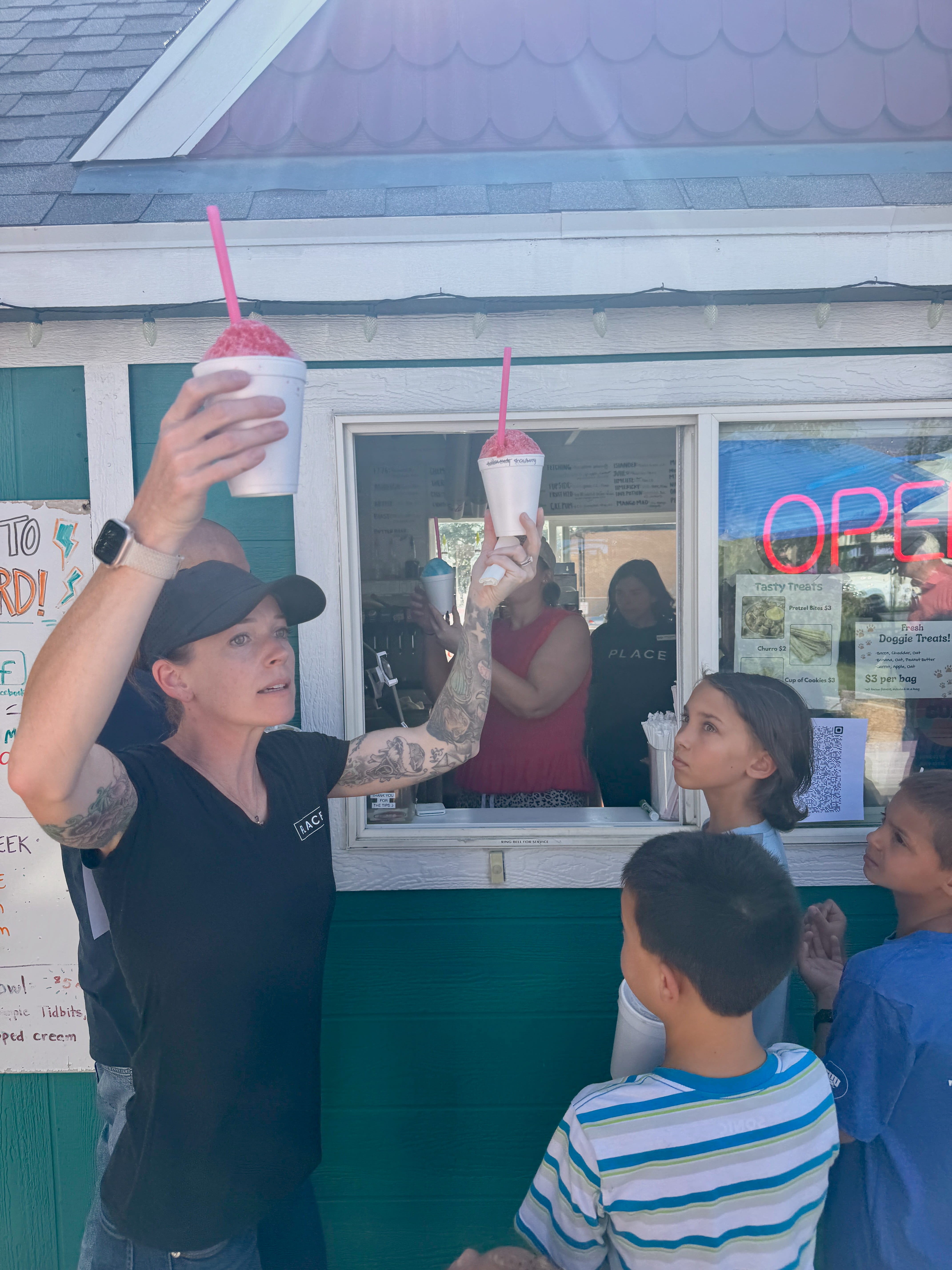 Cedar City customer appreciation event at Soda Nerd with real estate team serving sodas and snow cones to community