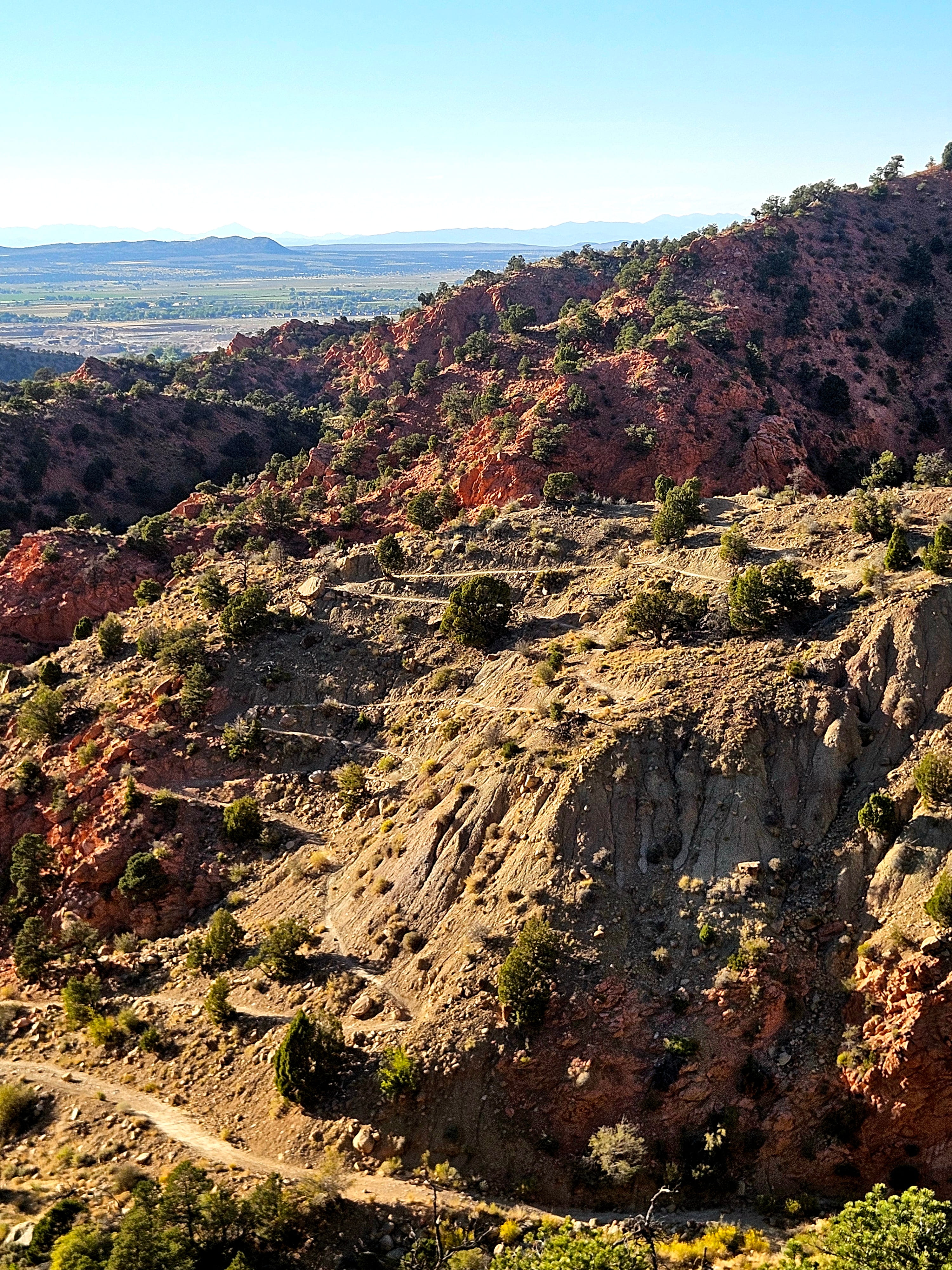 Colorful desert hillside along Lightning Switch Trail showing pink orange and purple rock formations near Cedar City