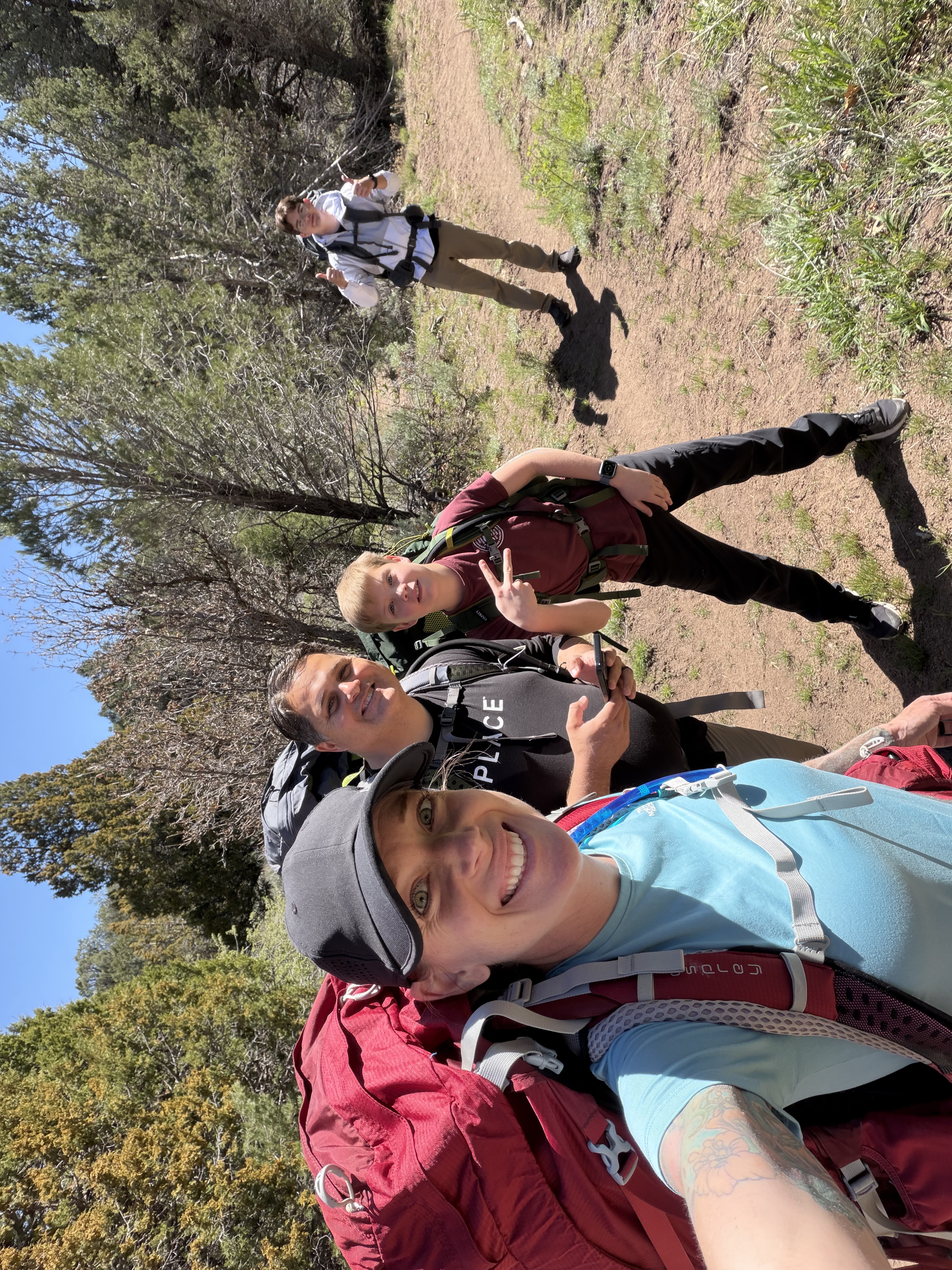 Family backpacking through mountain scenery near Cedar City, Utah