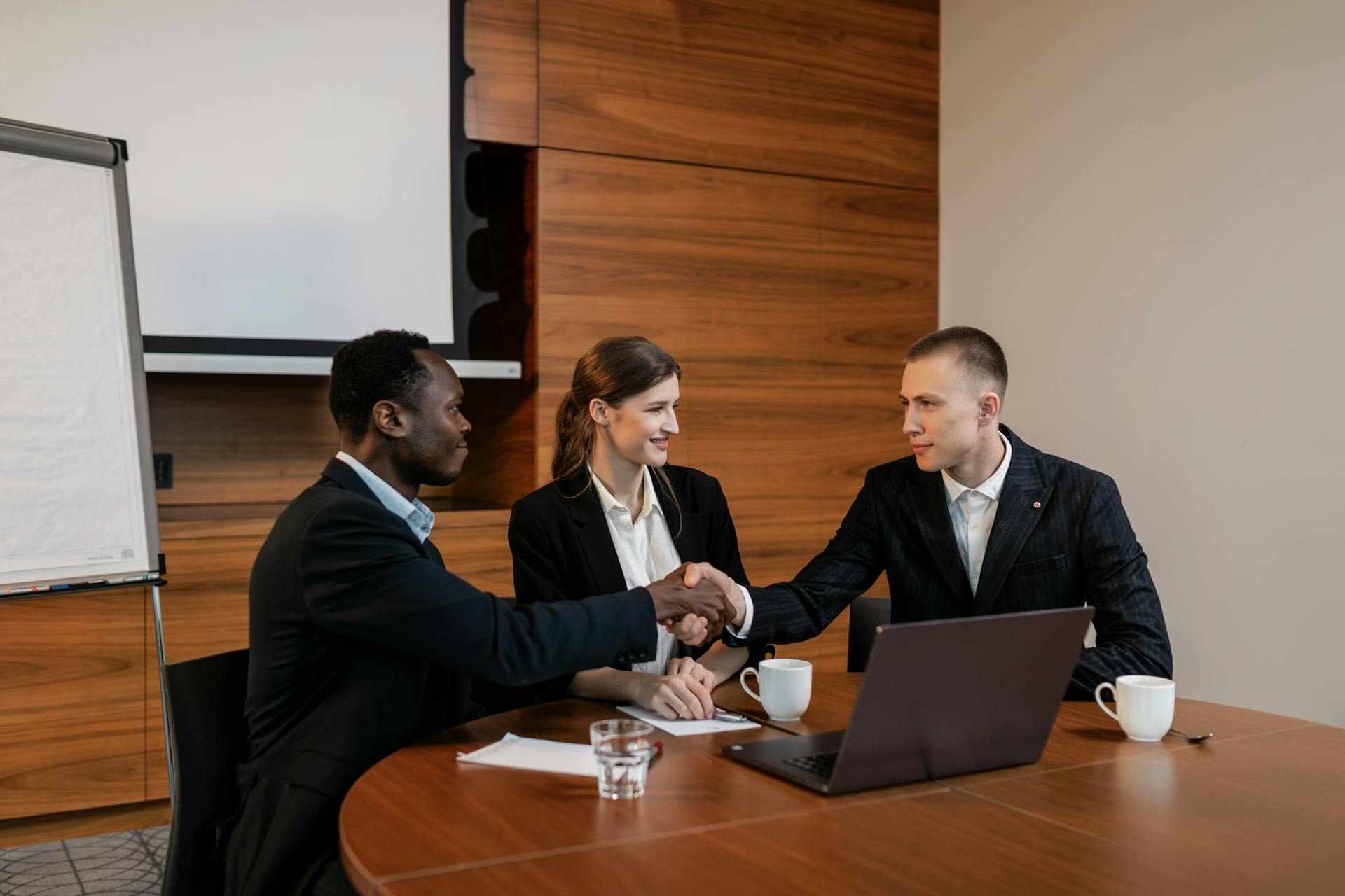 Photo by Alena Darmel: https://www.pexels.com/photo/a-woman-sitting-between-two-men-having-a-deal-8133997/