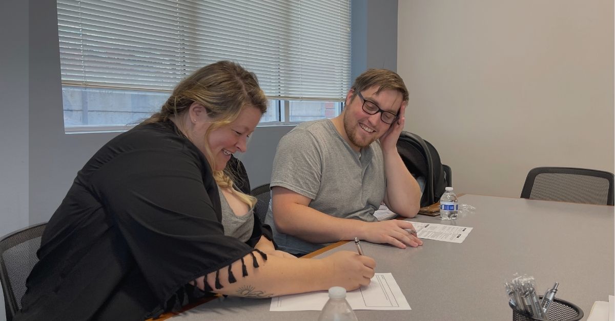 Eau Claire home buyers signing closing documents at a local Chippewa Valley title company office