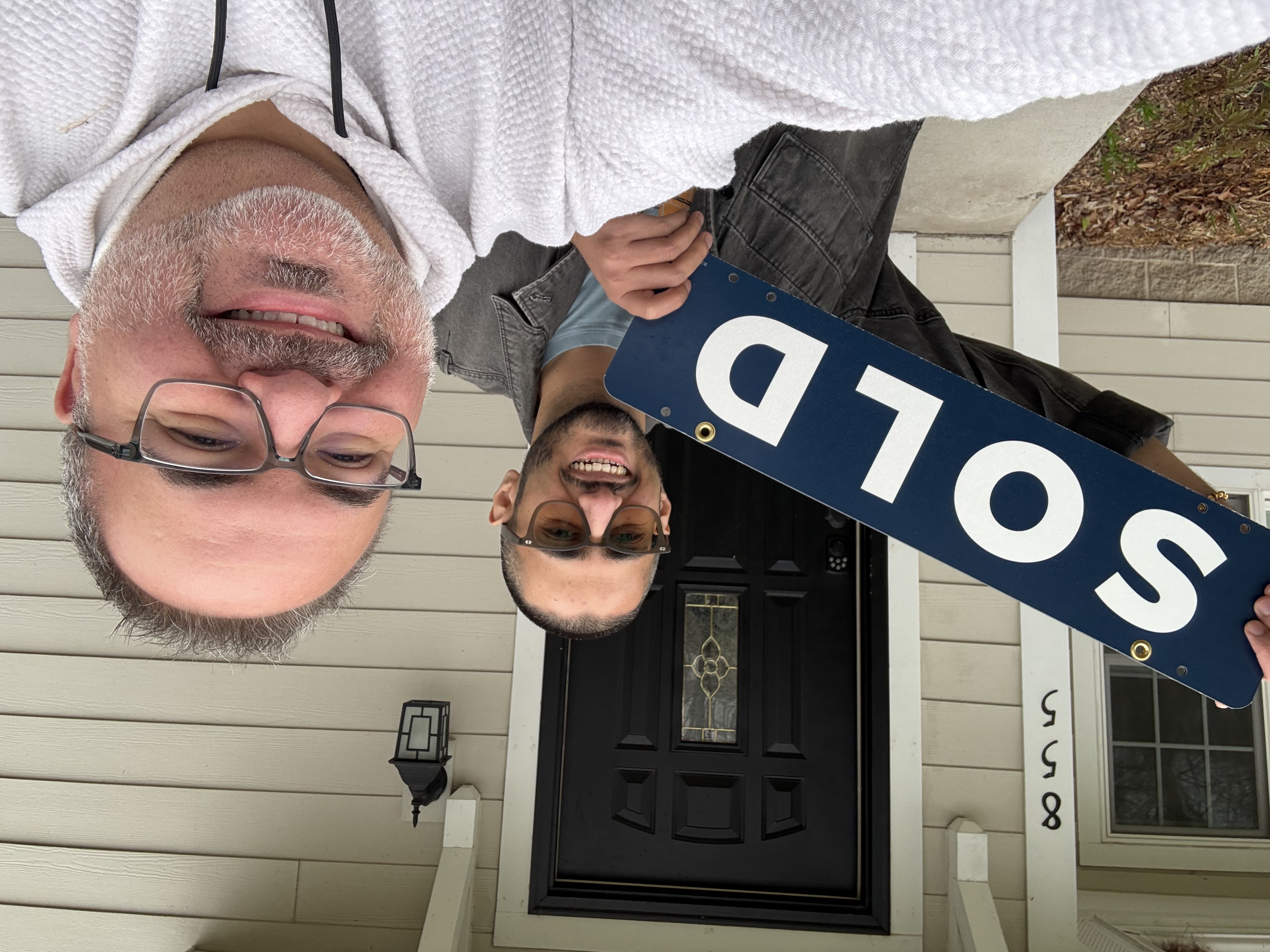 Eau Claire home buyer celebrating a successful purchase with Realtor Brad Bemowski outside their new home