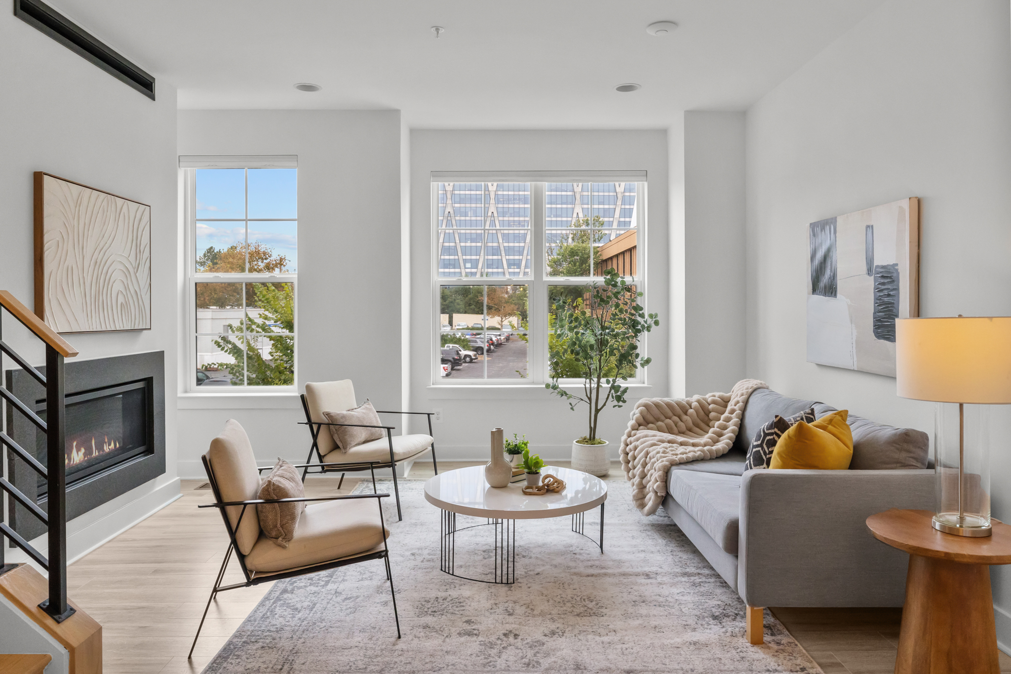 Modern living room with large windows, contemporary furniture, and natural light in a Northern Virginia townhouse near Reston and Tysons.
