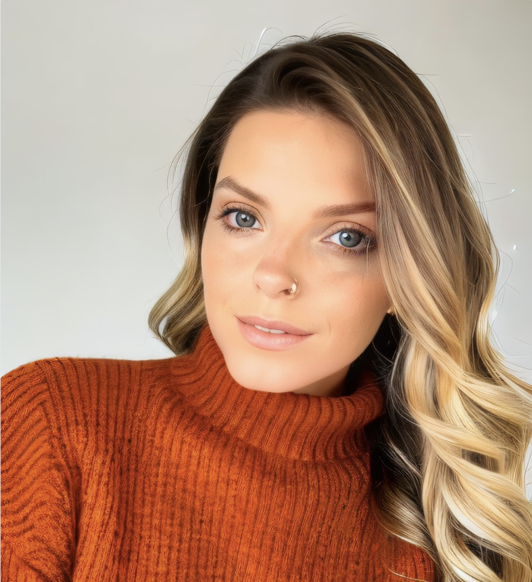 realtor in arkansas with blonde hair and a red sweater