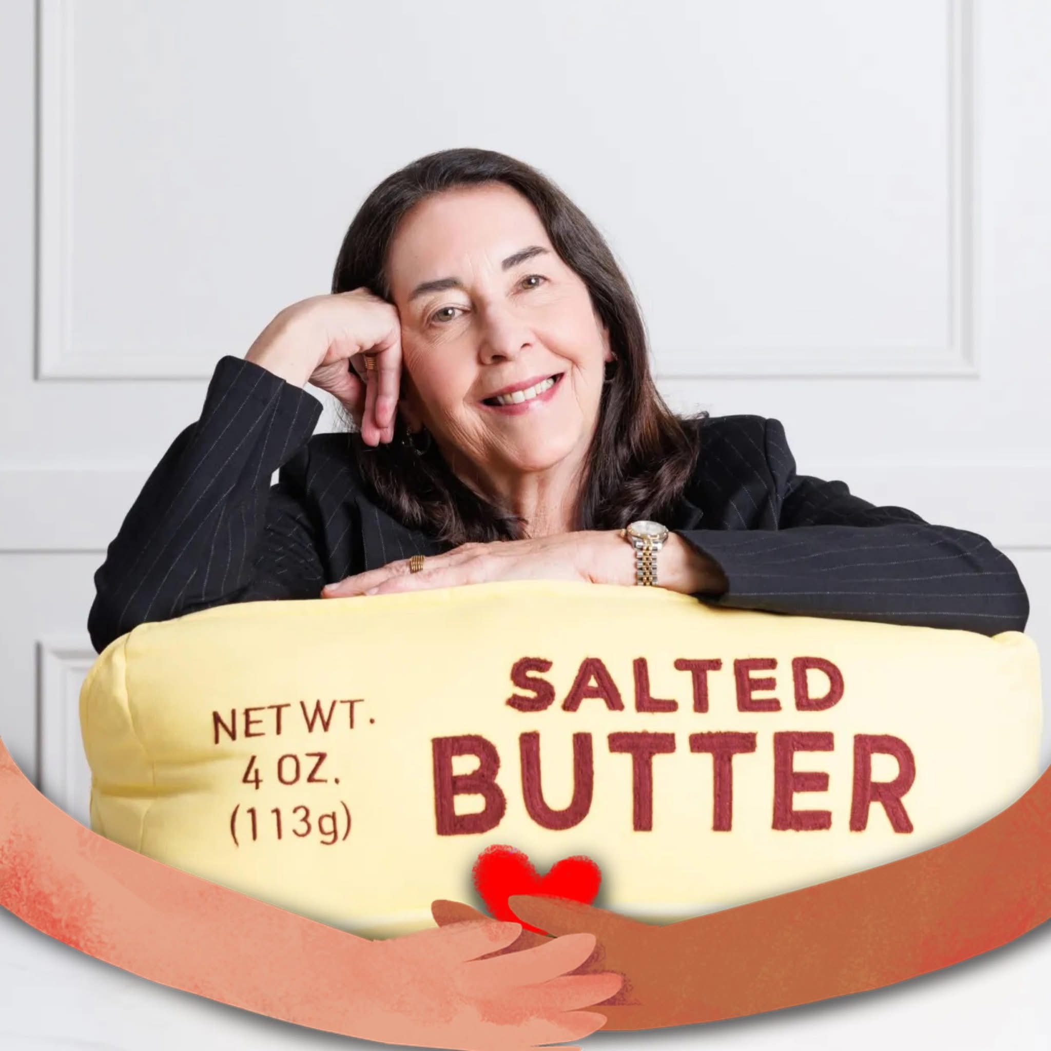 white woman smiling with brown hair in a black blazer