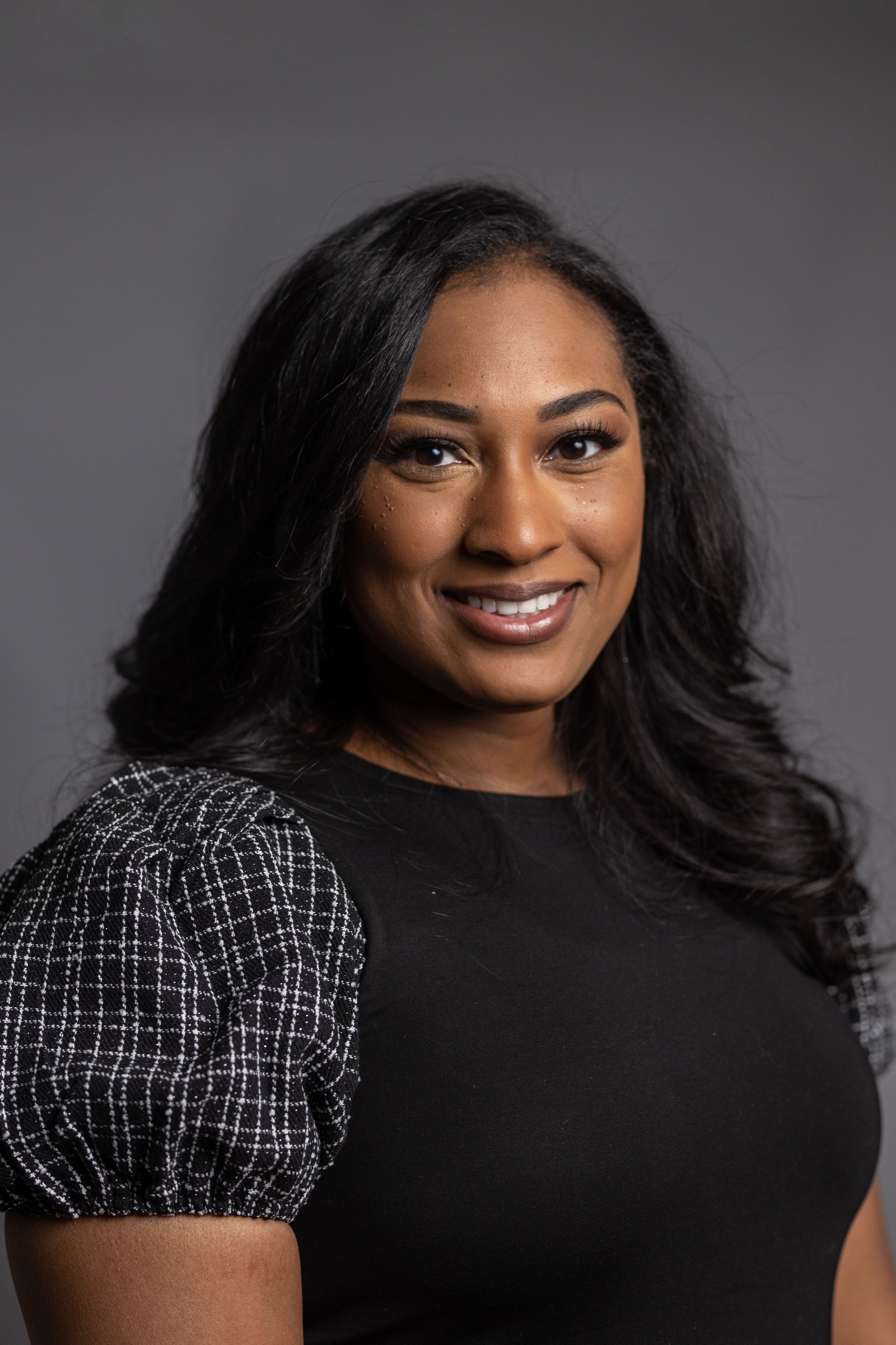 female realtor in arkansas with a black top and black hair