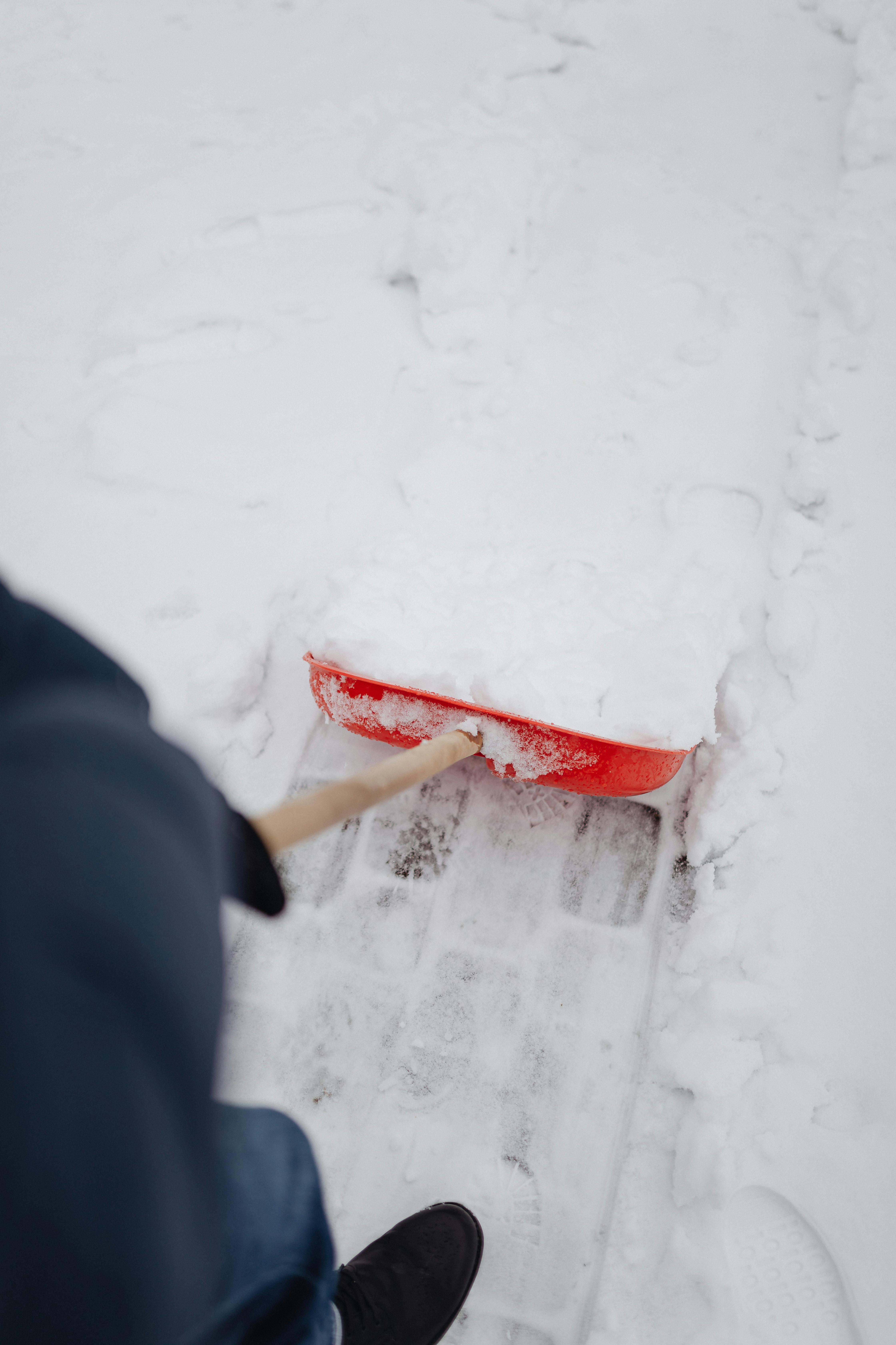 Person shoveling their home walkway